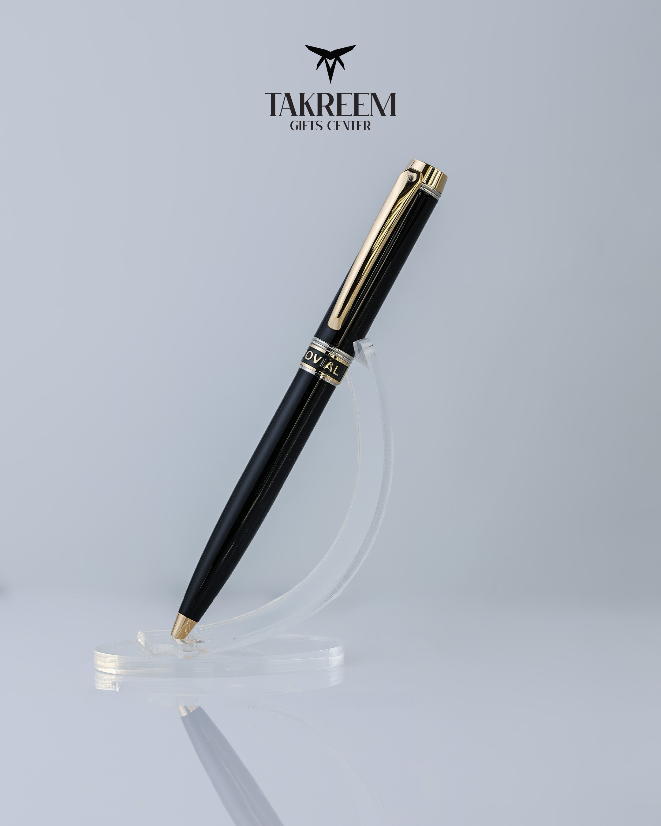 Black and gold pen on a clear stand with 'Takreem Gifts Center' logo above.