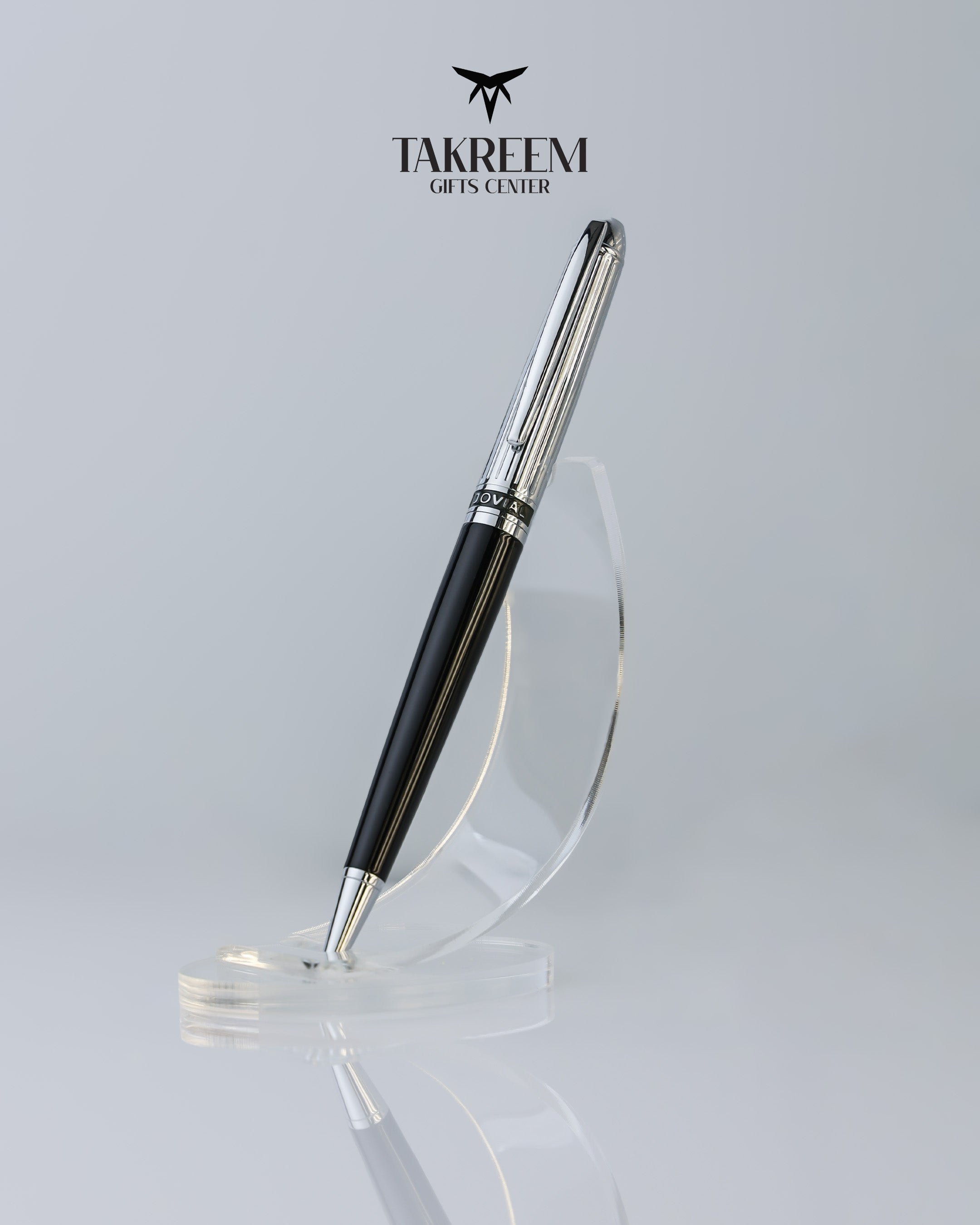 Luxury pen on a clear stand with 'Takreem Gifts Center' branding.