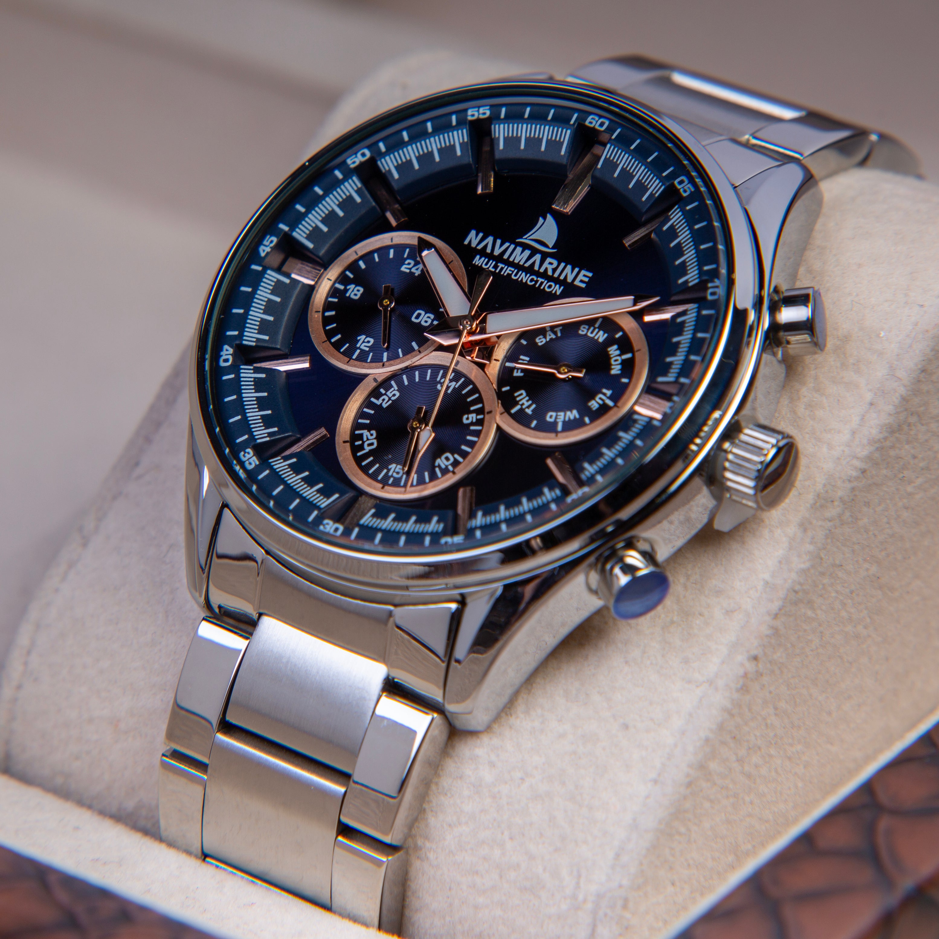 Silver wristwatch with a blue face on a light gray background