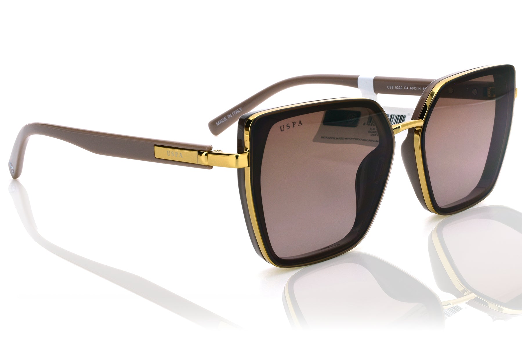 Sunglasses with gold frame and dark lenses on a white background