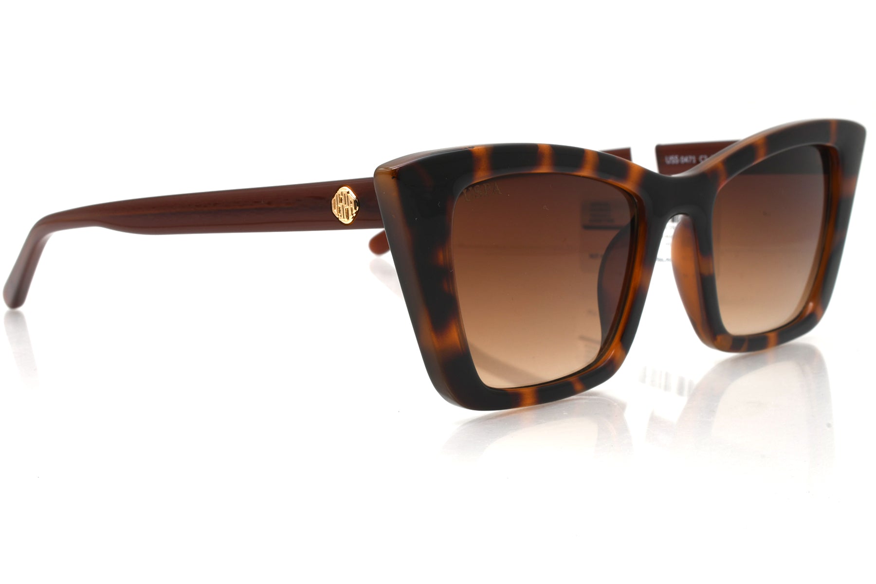 Sunglasses with tortoiseshell frame and brown gradient lenses on a white background