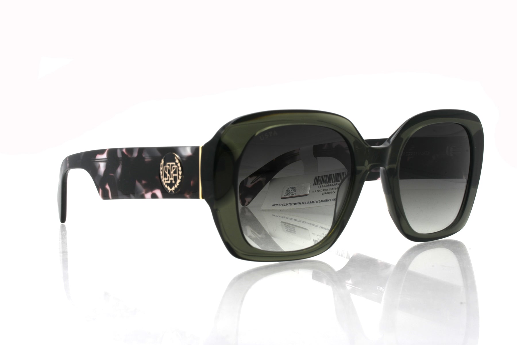 Green sunglasses with floral pattern on arm against a white background