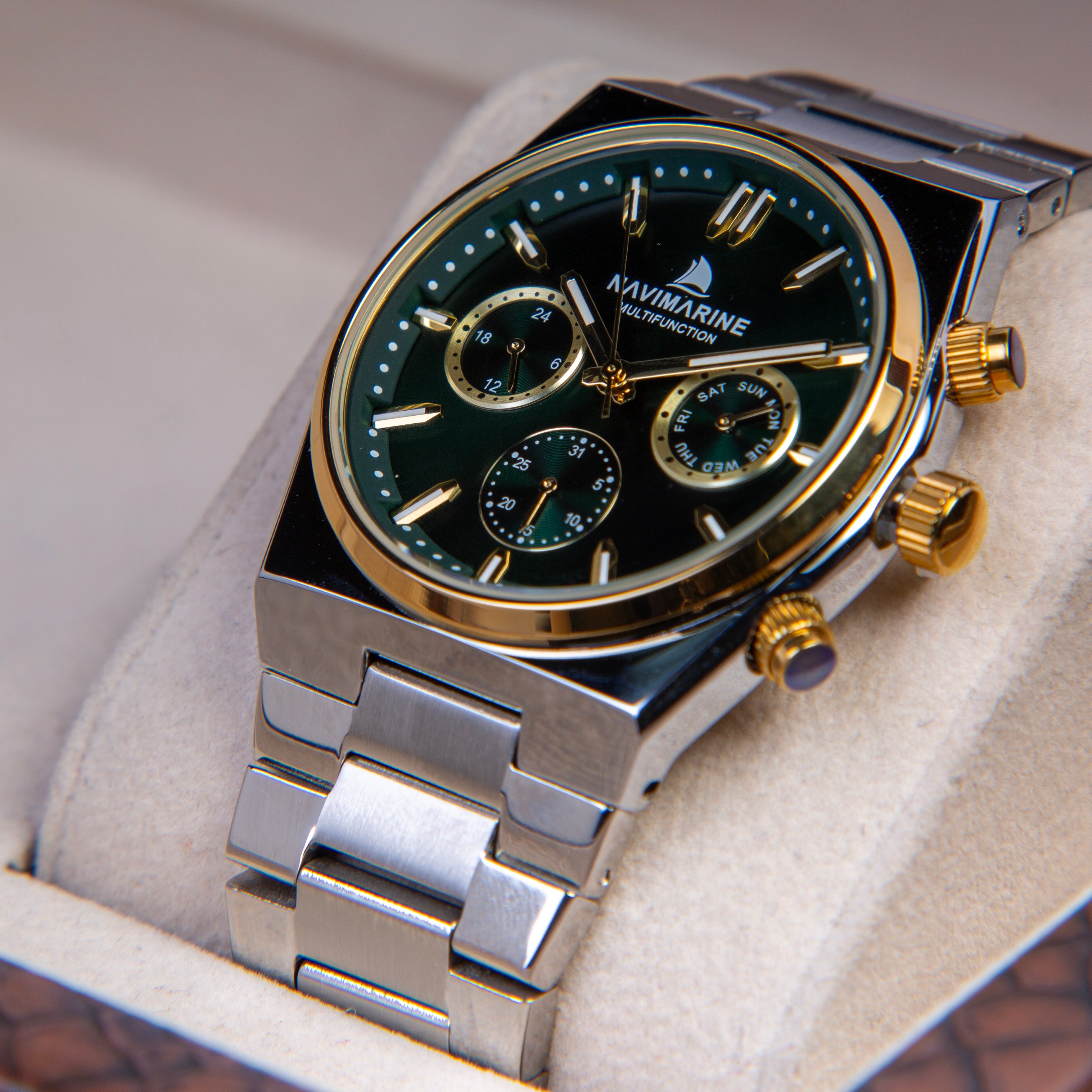 Luxury watch with black dial and gold accents in a box, brand 'Navimarine' visible