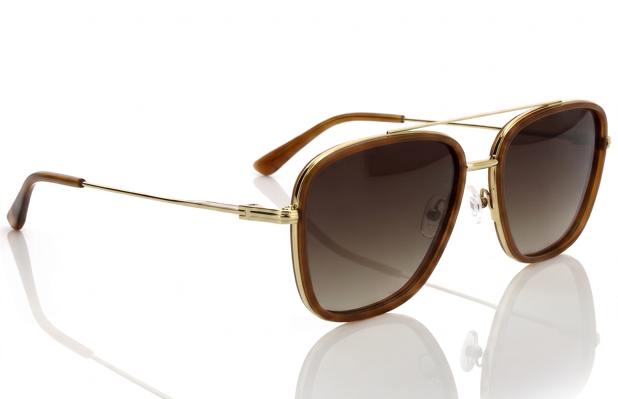 Gold-framed sunglasses with brown gradient lenses on a white background