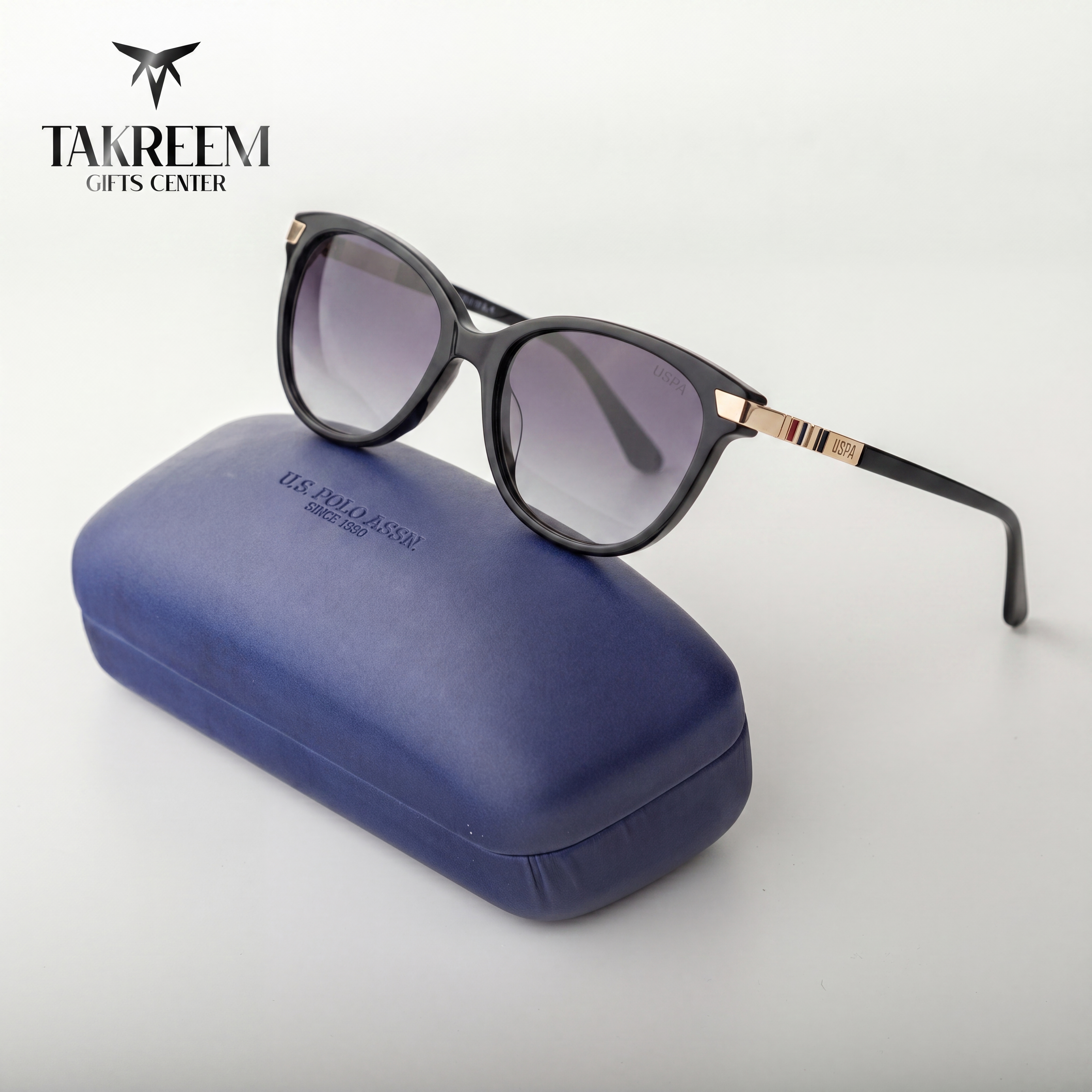 Sunglasses with a blue case on a white background, featuring the Takreem Gifts Center brand.