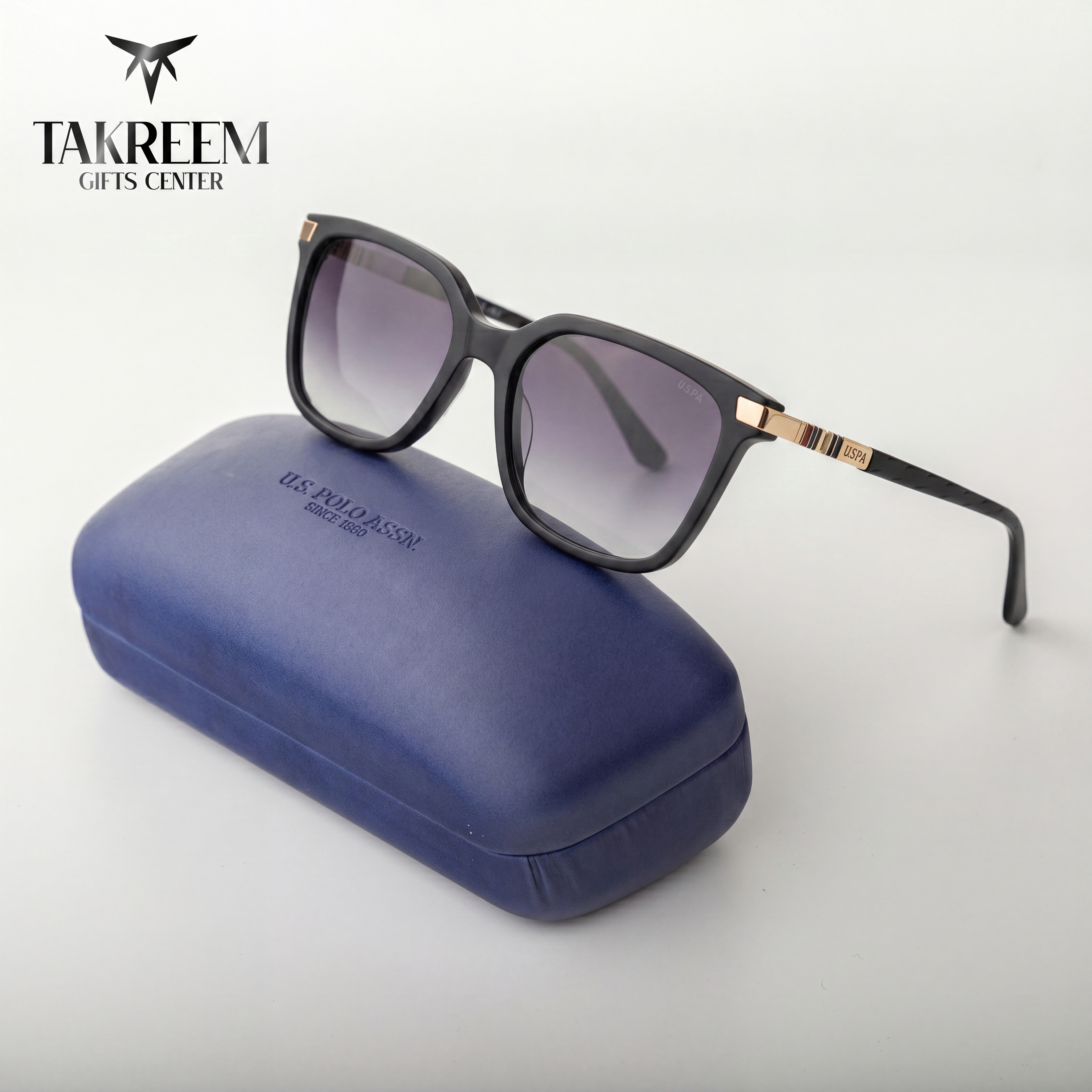 Sunglasses with a blue case on a white background, featuring the Takreem Gifts Center logo.
