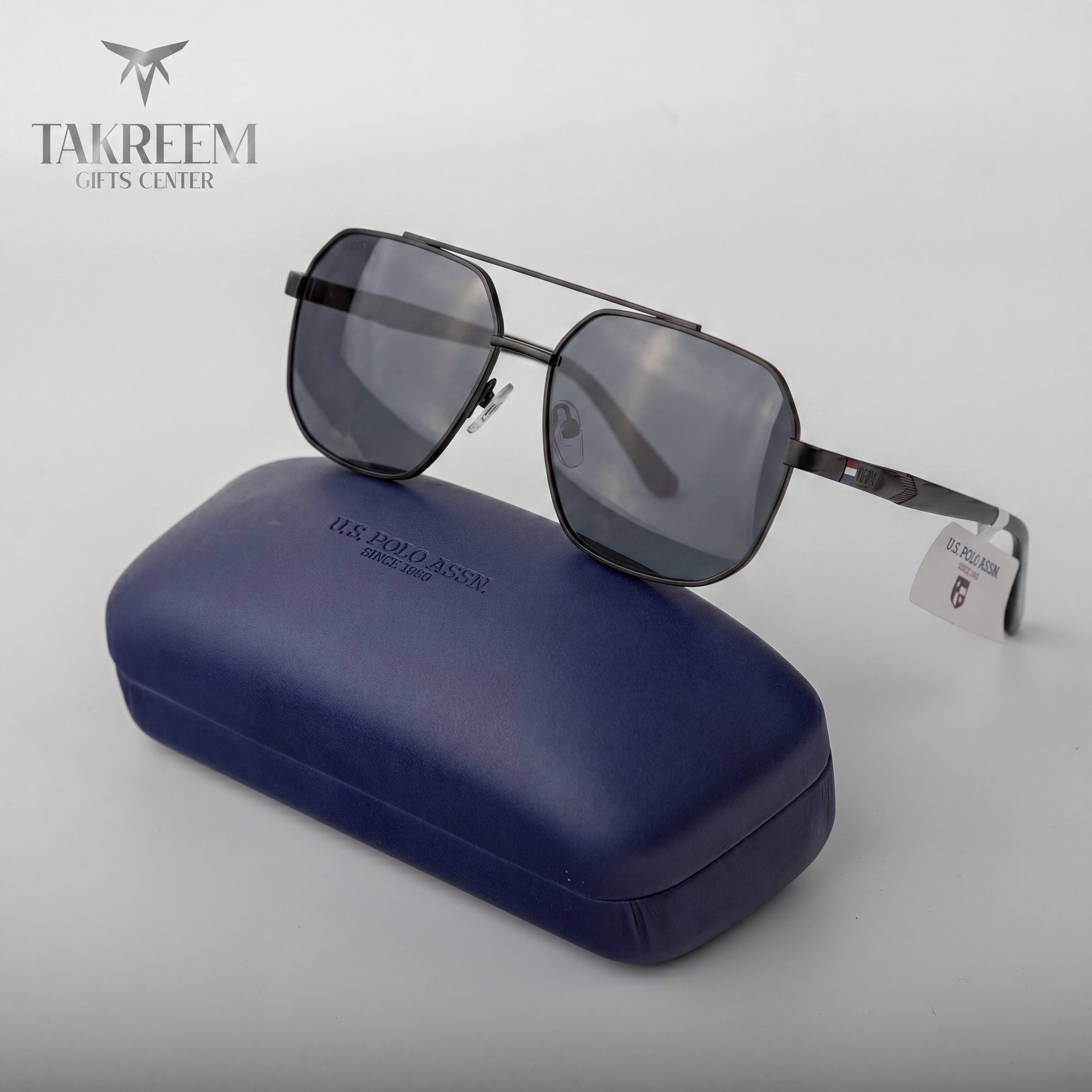 Sunglasses with a blue case on a white background, featuring the brand 'Takreem'.