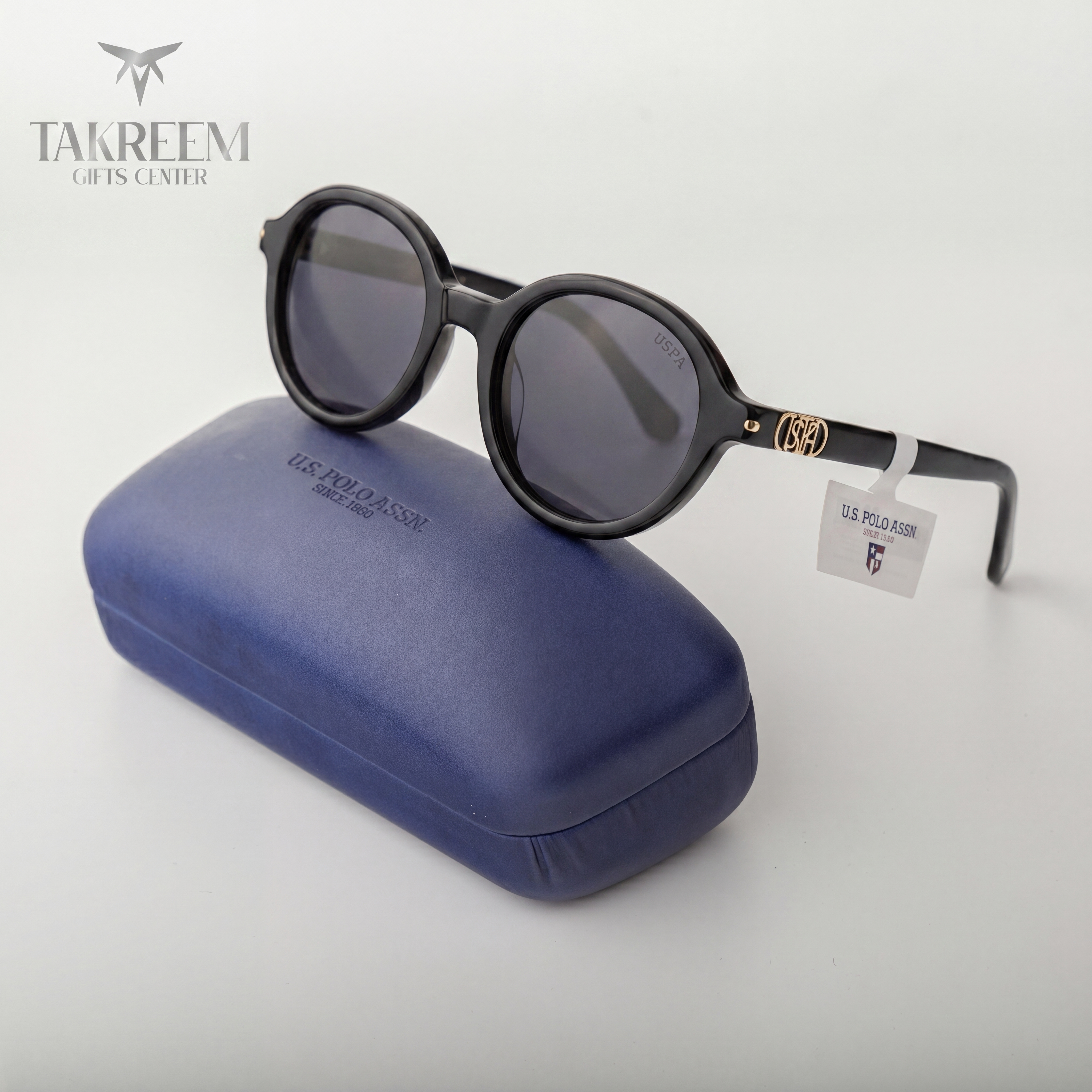 Sunglasses with a blue case on a white background, featuring U.S. Polo Assn. branding.