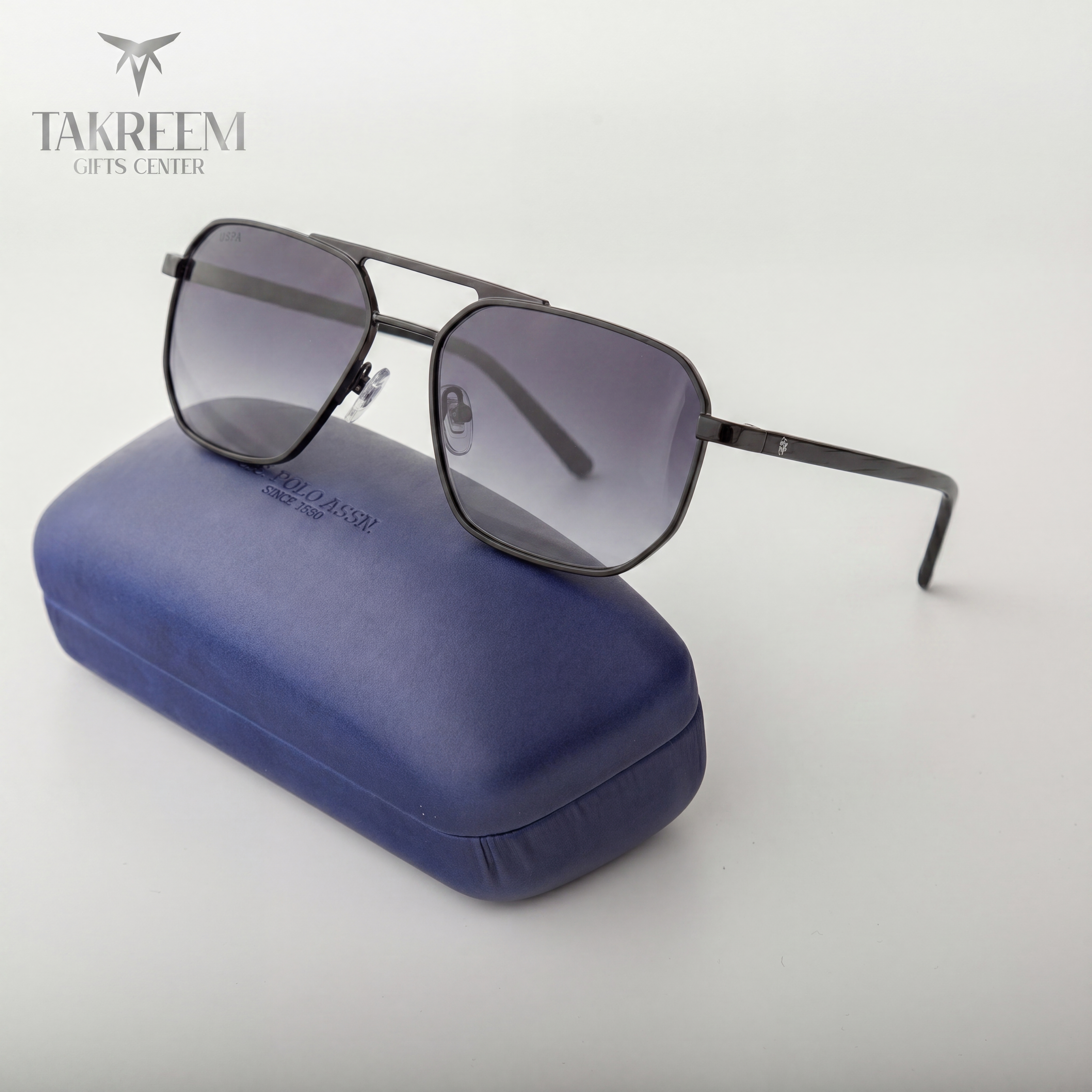 Sunglasses with a blue case on a white background, featuring the Takreem Gifts Center logo.