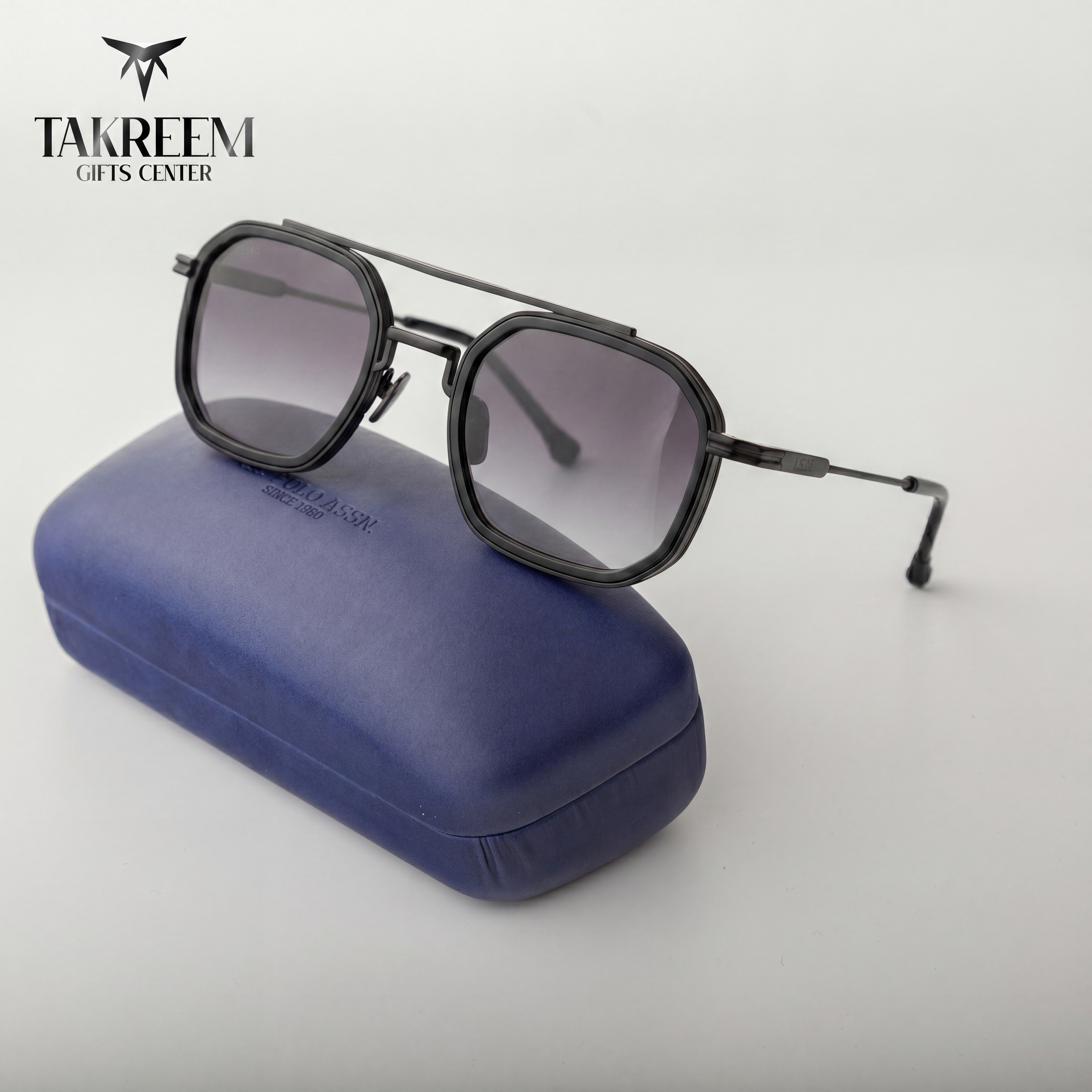 Sunglasses with a blue case on a light gray background, featuring the Takreem Gifts Center logo.