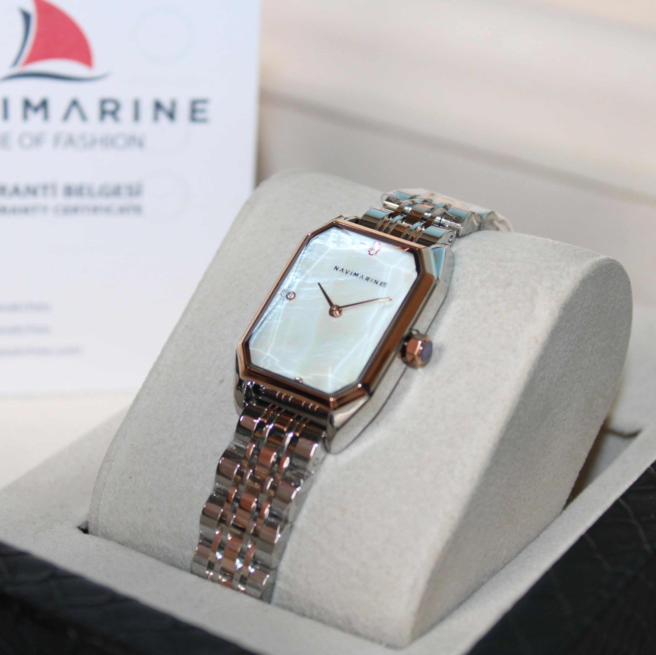 Navimarine watch on a display stand with brand logo in the background