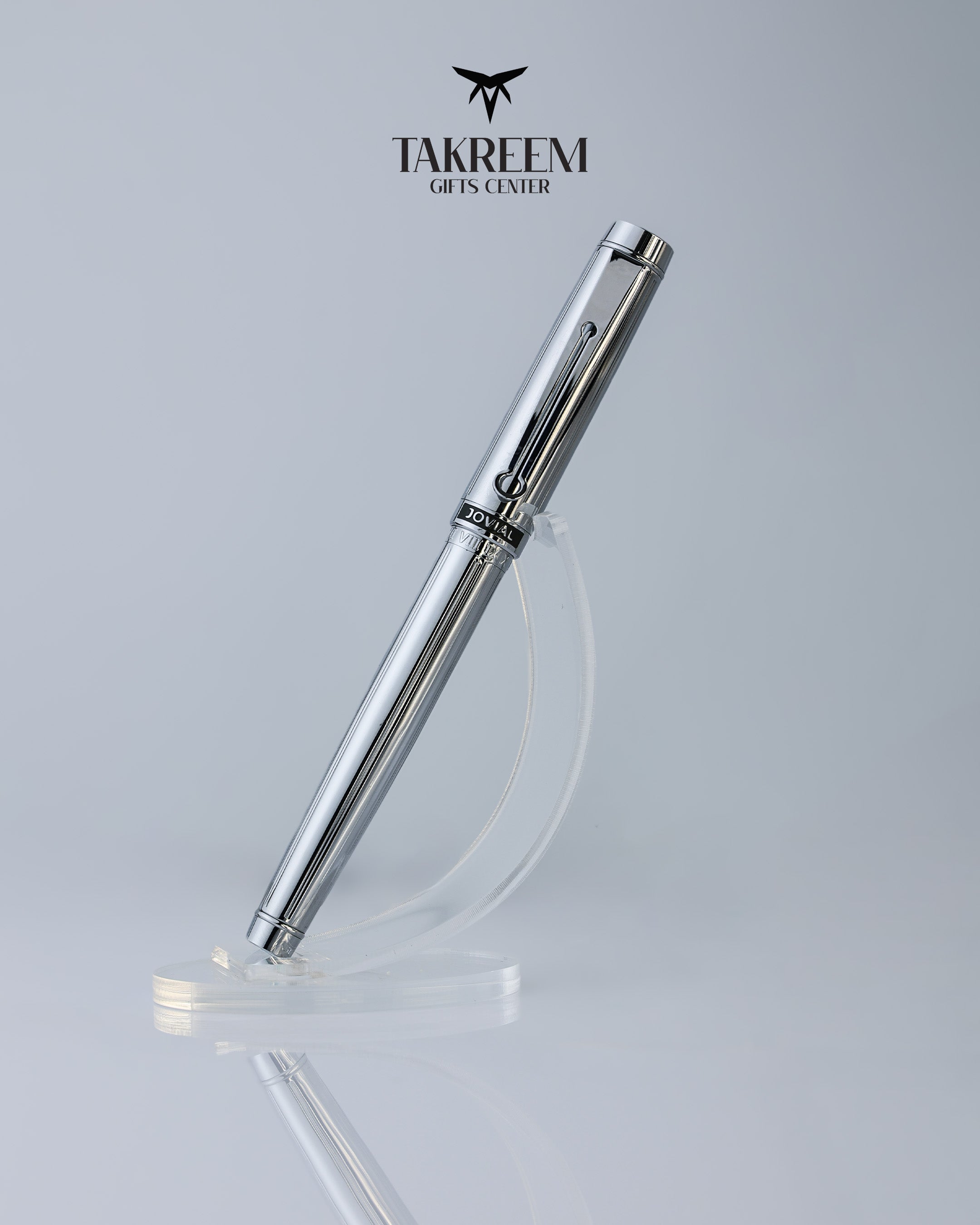 Silver pen on a clear stand with 'Takreem Gifts Center' branding on a light gray background