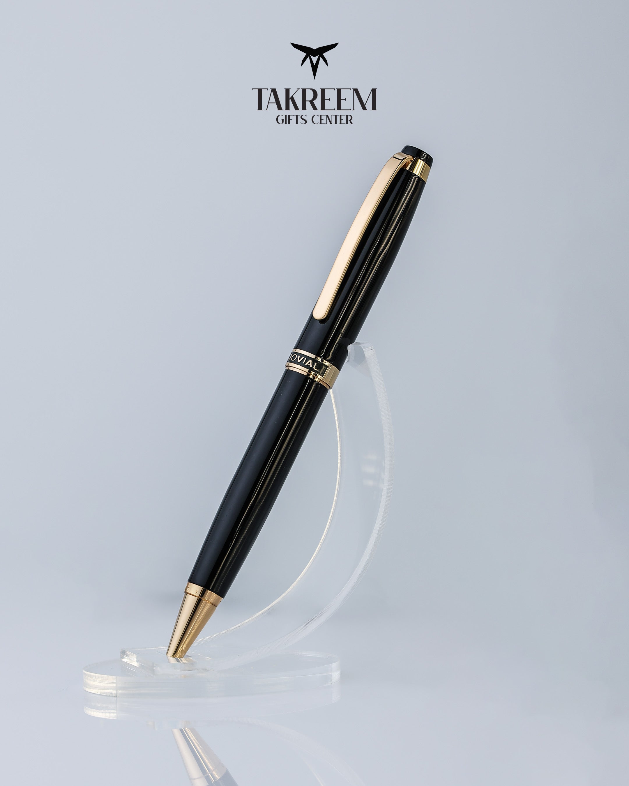 Black pen with gold accents on a light gray background, featuring the Takreem Gifts Center logo.