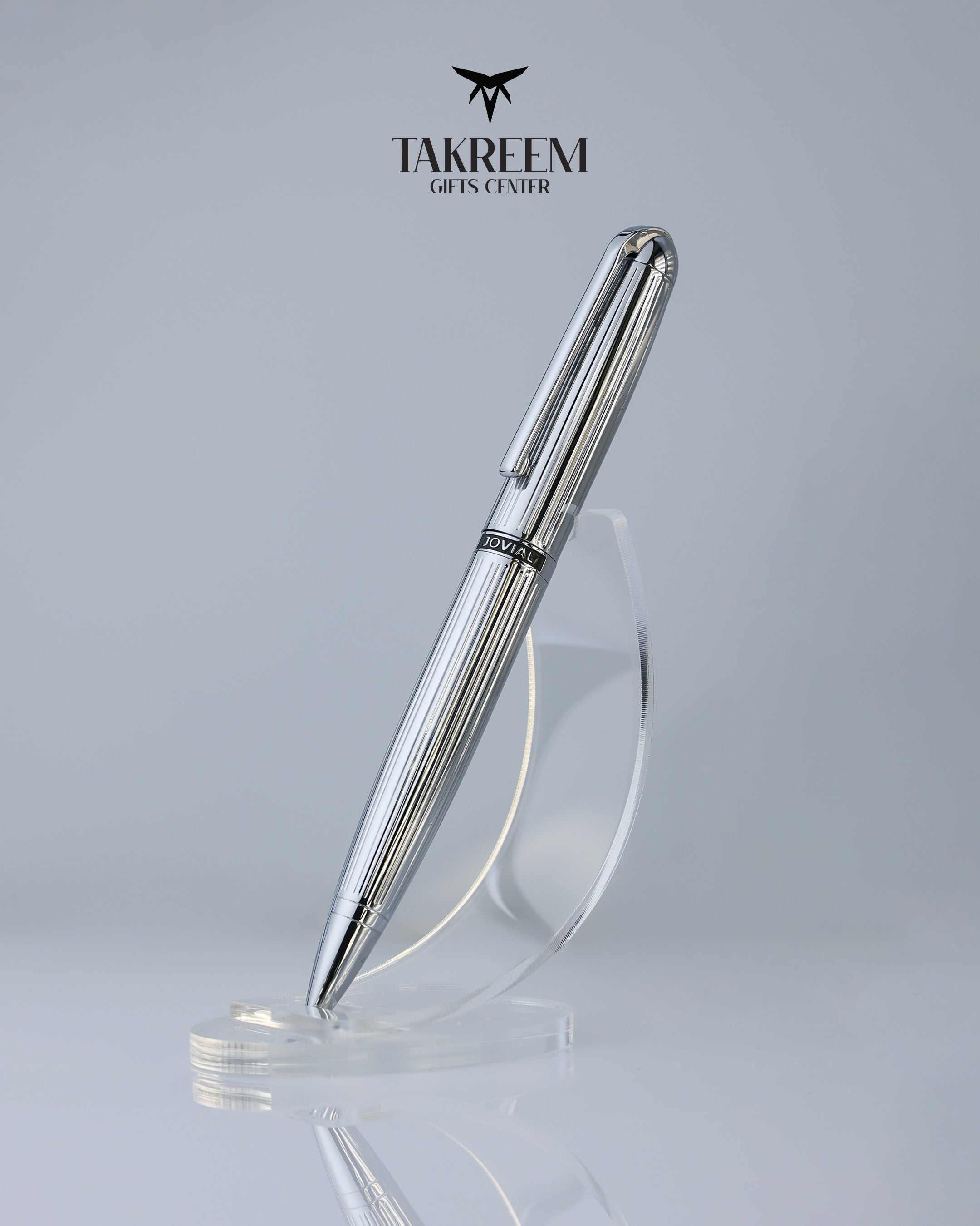 Silver pen on a clear stand with 'Takreem Gifts Center' branding on a light gray background