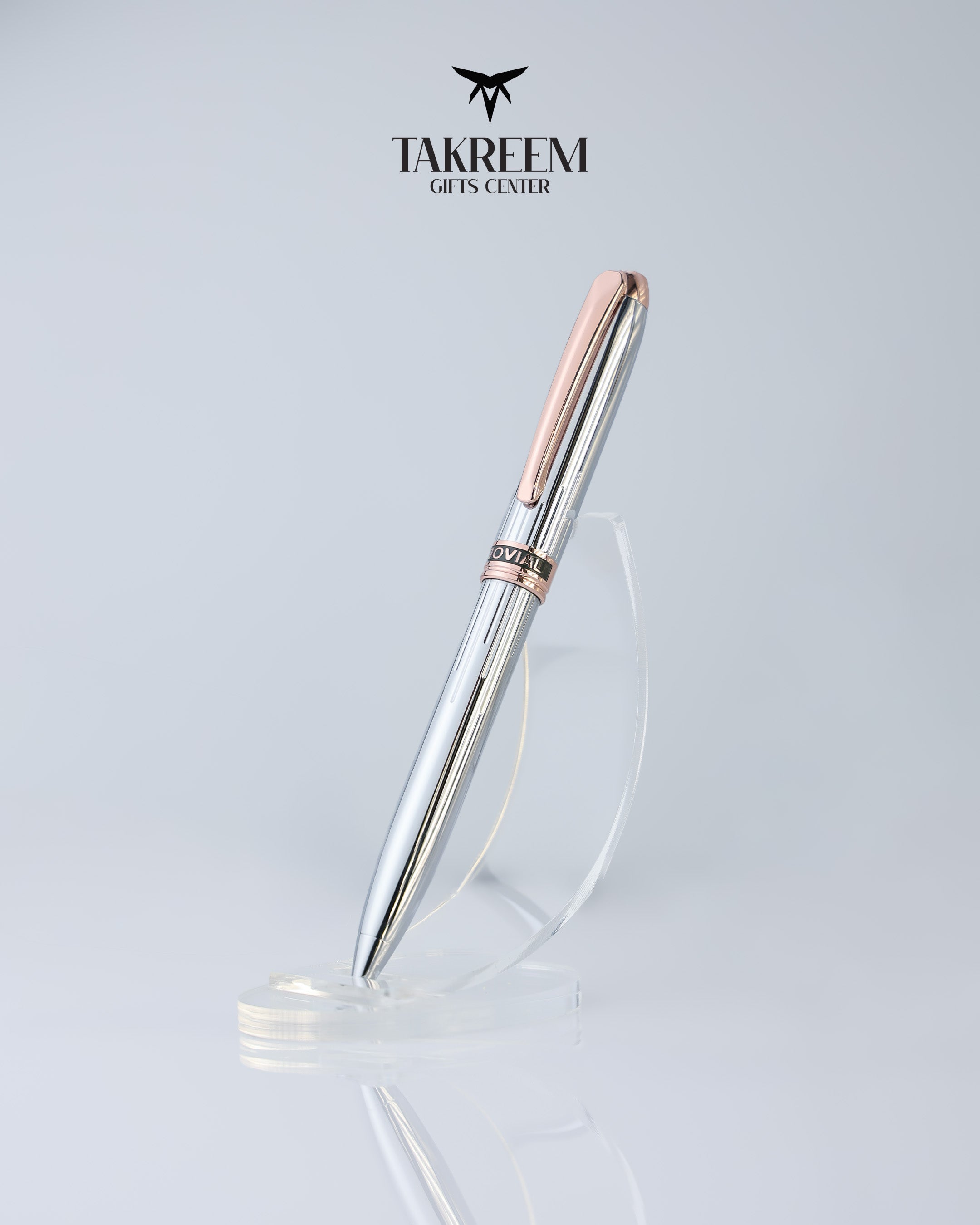 Silver pen with rose gold accents on a light gray background, featuring the Takreem logo.