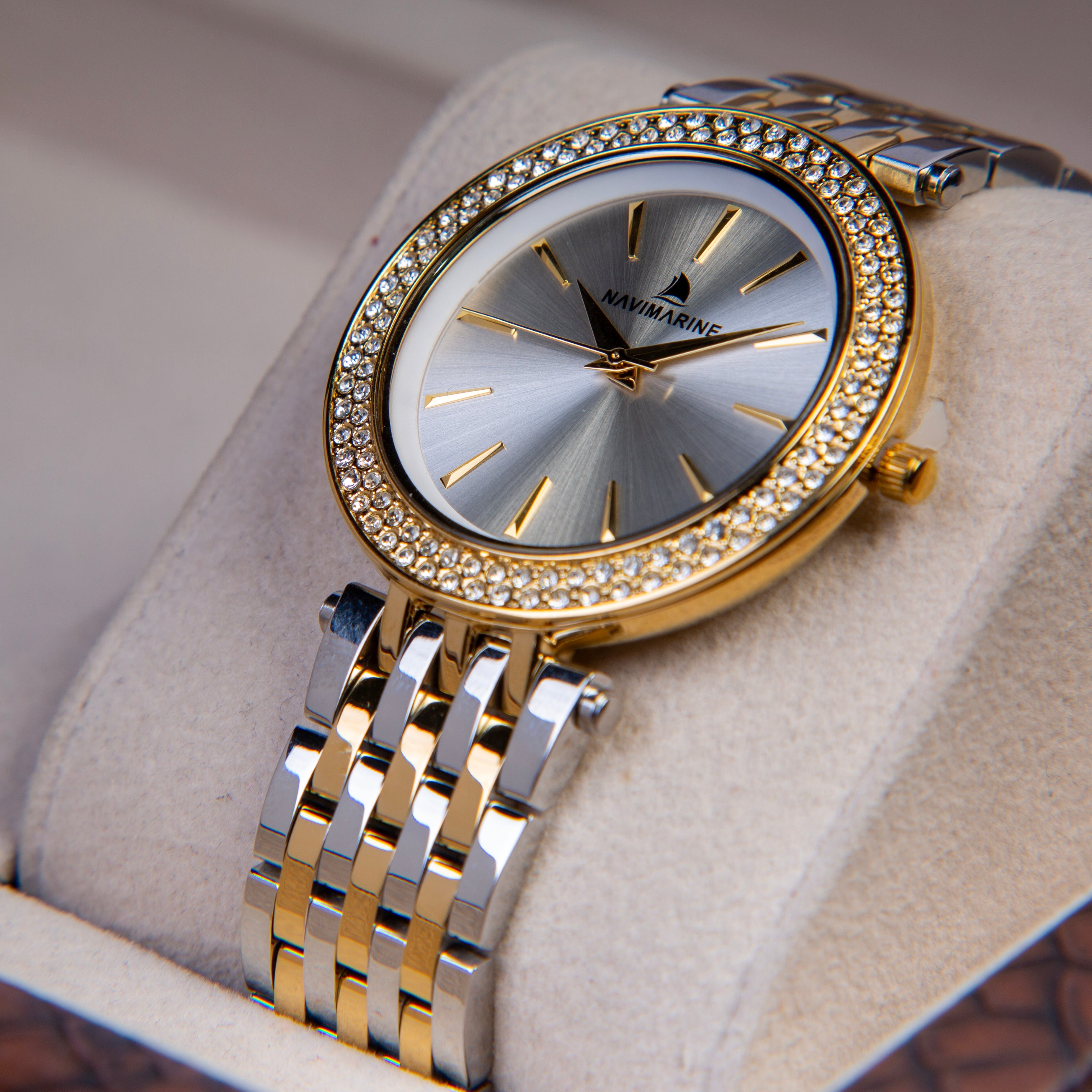 Luxury watch with gold and silver band on a soft surface