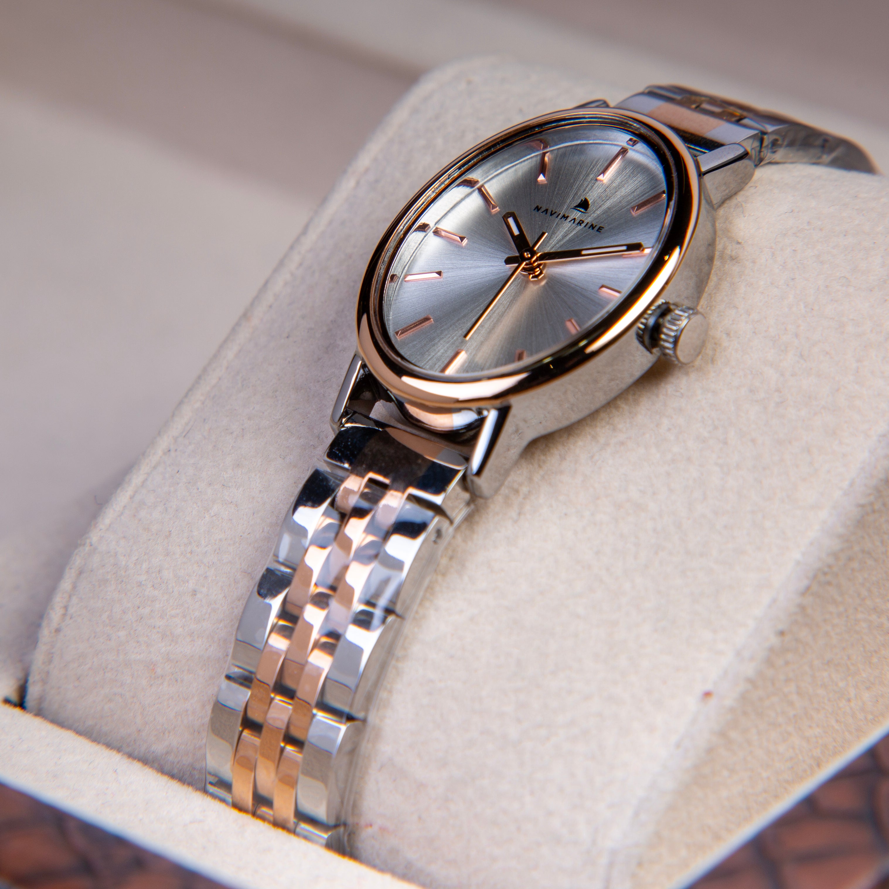 Silver and rose gold watch on a soft surface