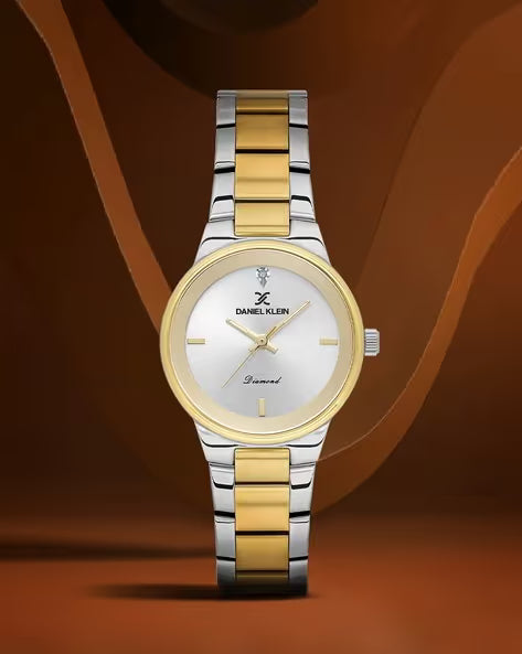 Two-tone silver and gold watch on a brown background