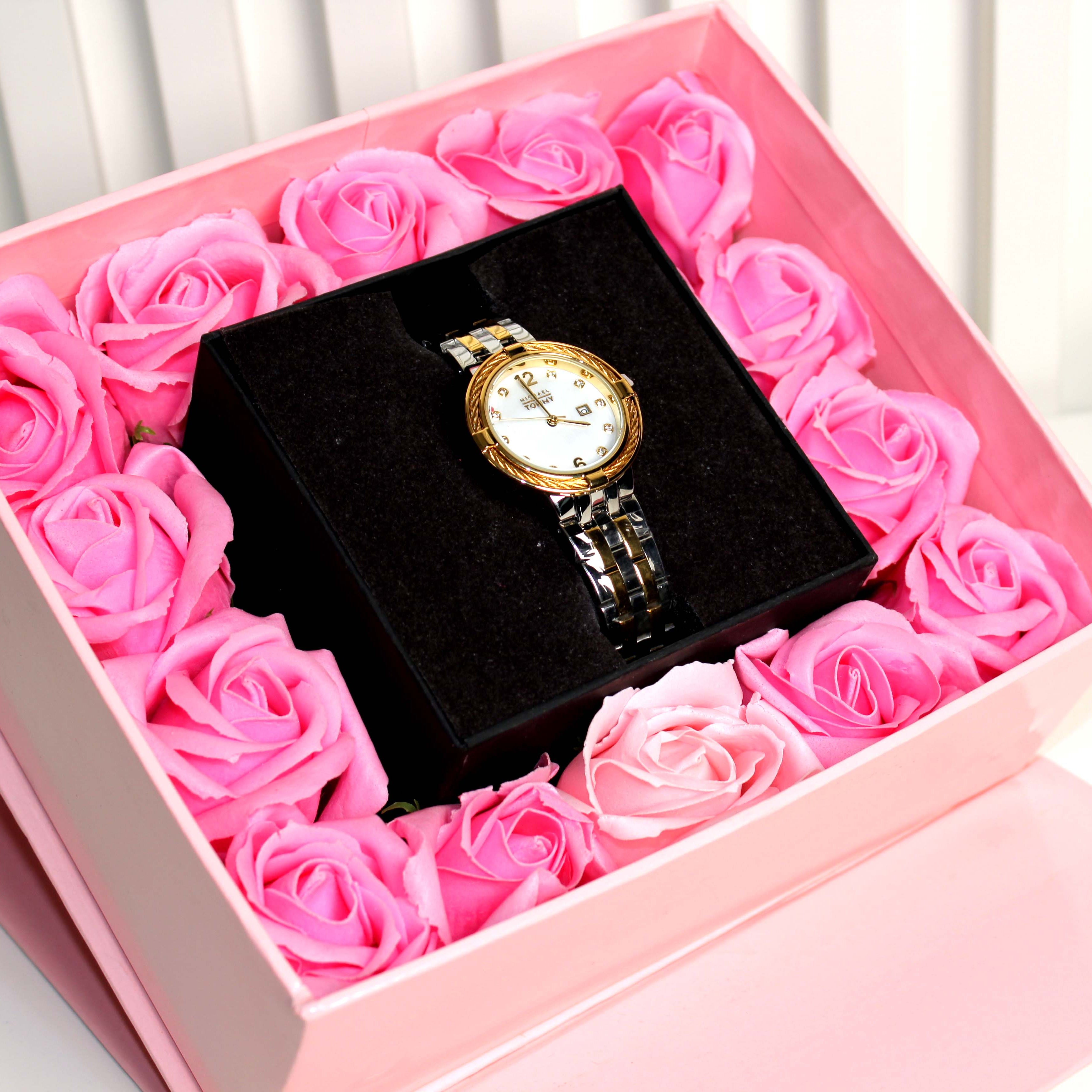 Watch in a box surrounded by pink roses