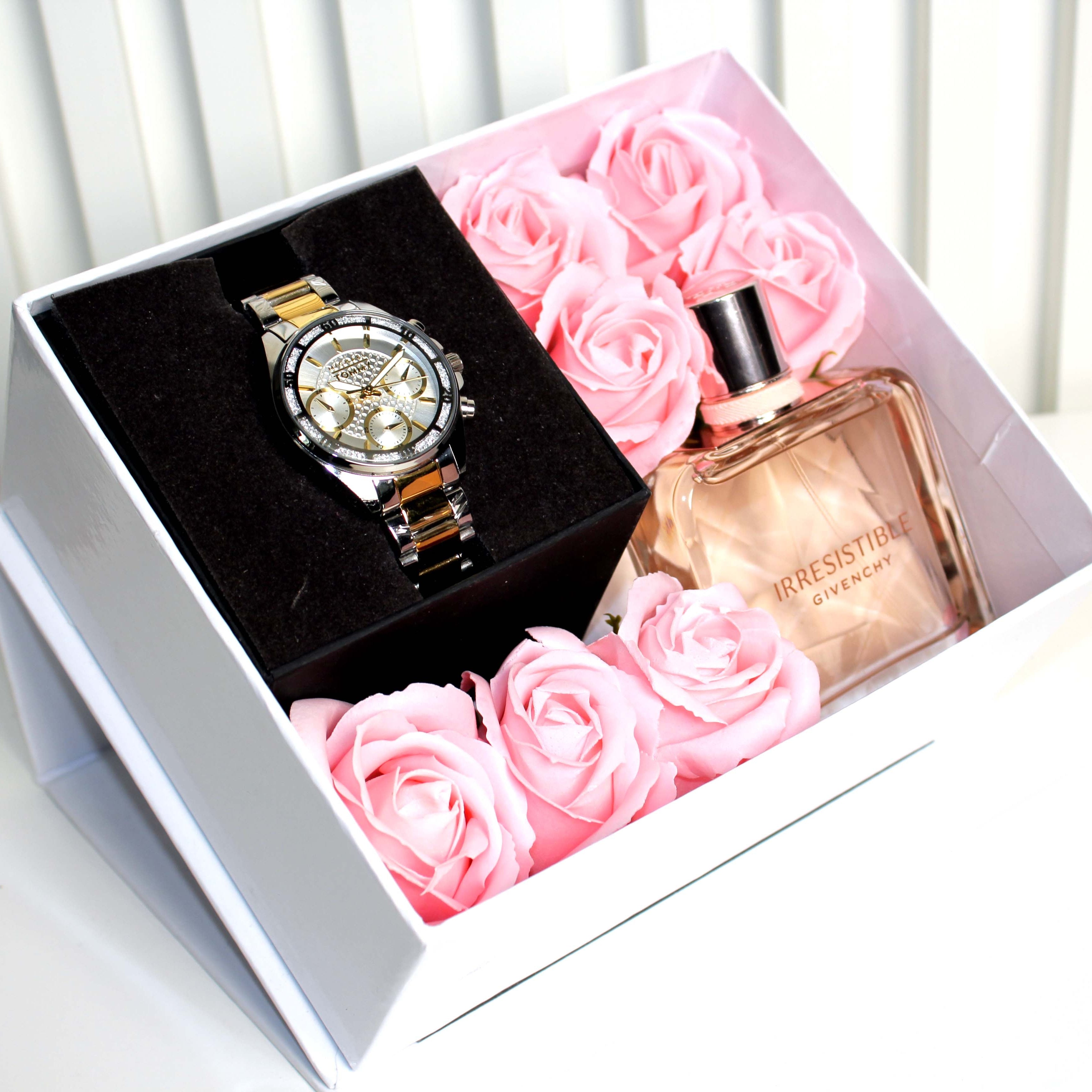 Watch and perfume bottle in a box with pink roses