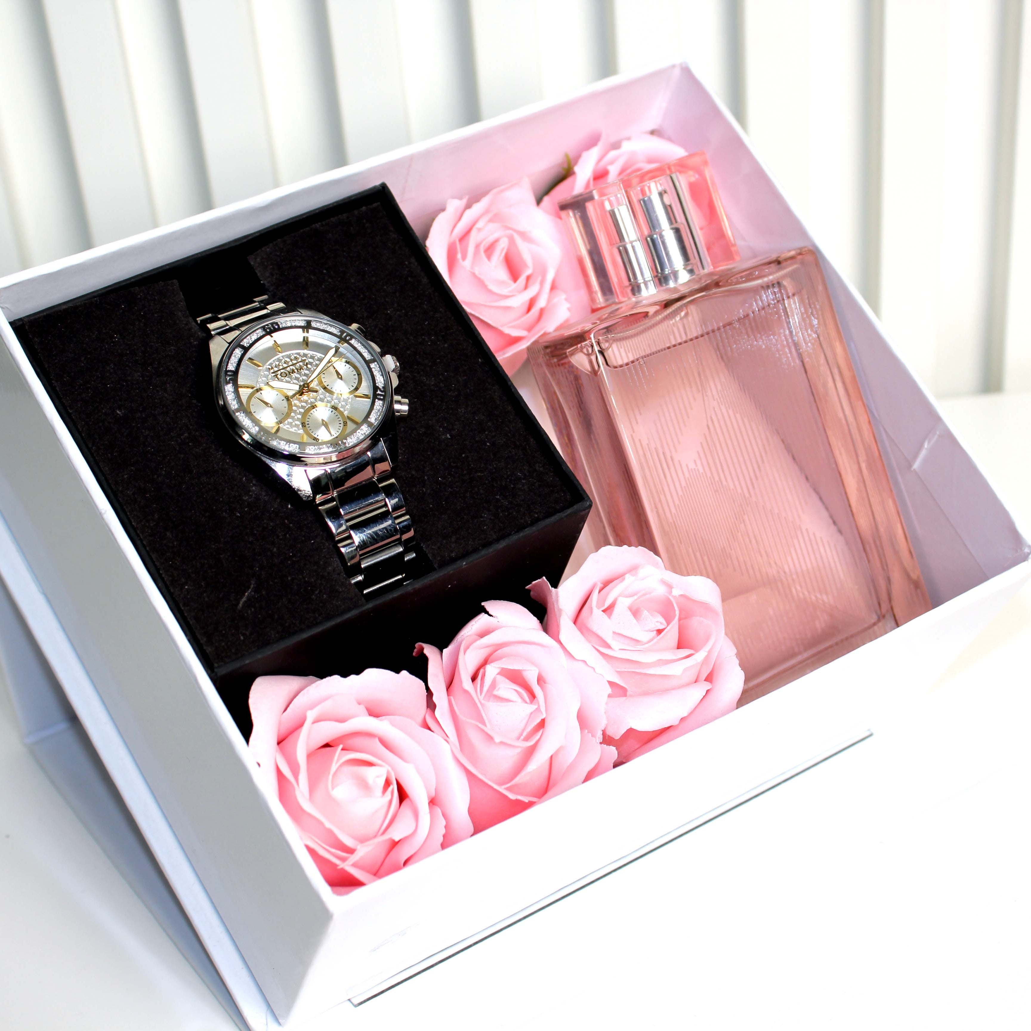 Watch and perfume with pink roses in a box