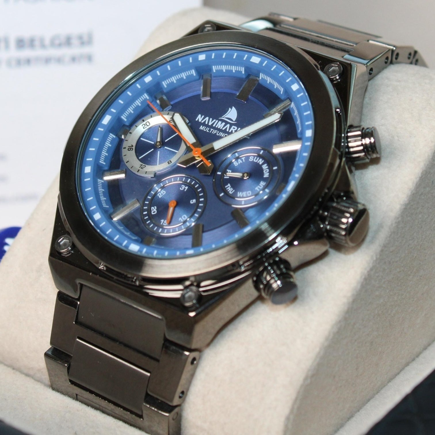 Navimag watch with blue face and black strap on a white cushion