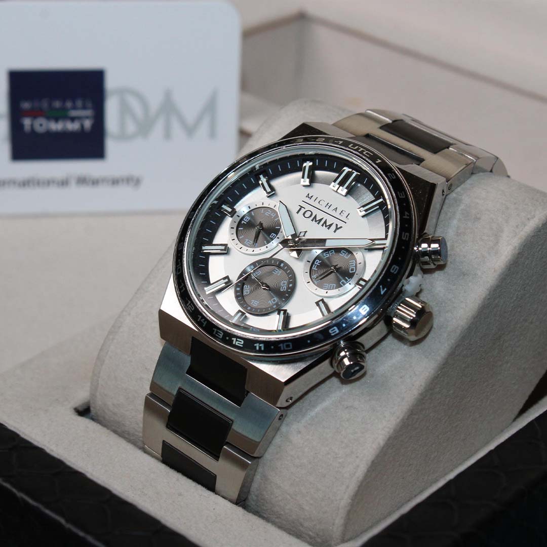 Silver watch with white face in a display case, Tommy Hilfiger brand visible