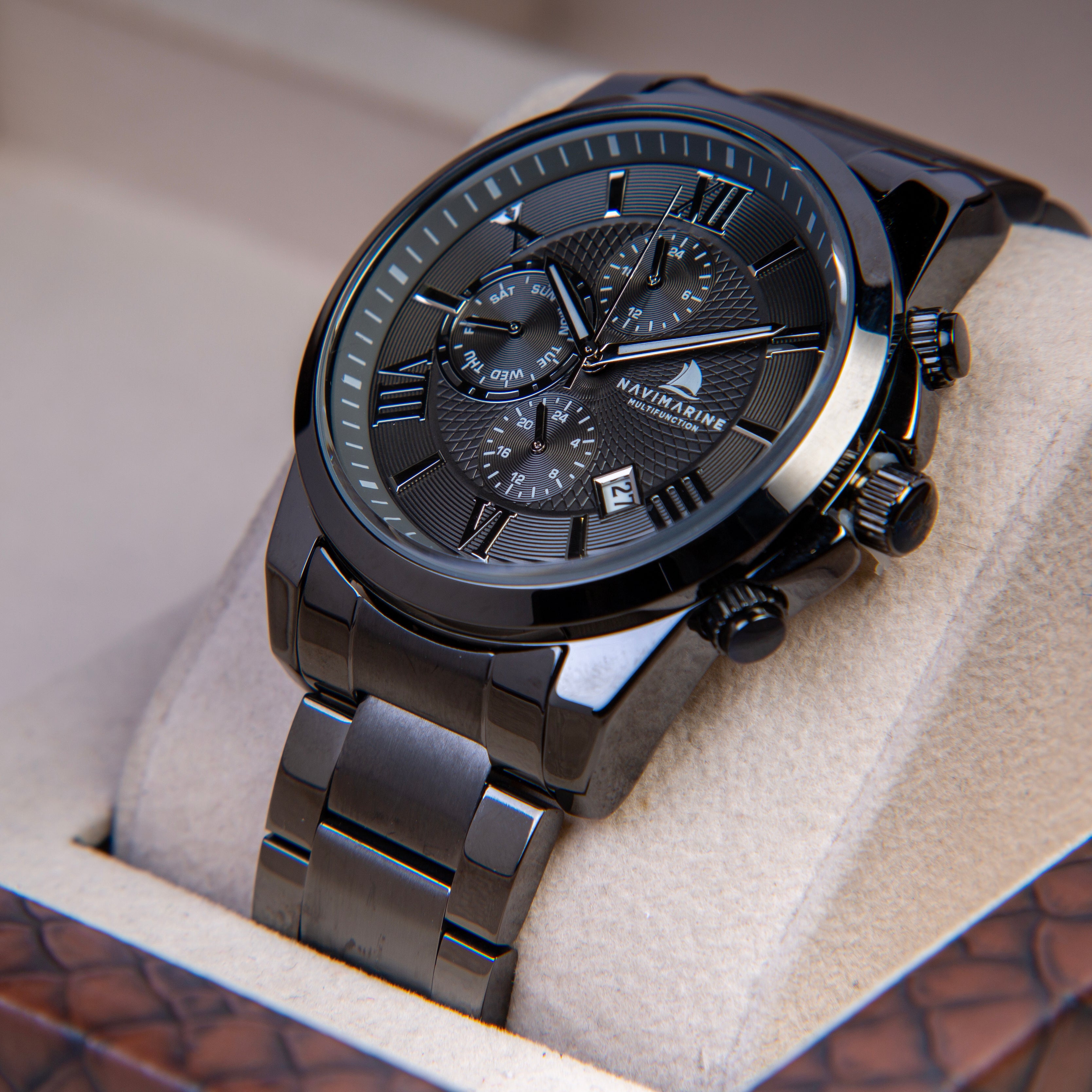 Black wristwatch with detailed face in a box