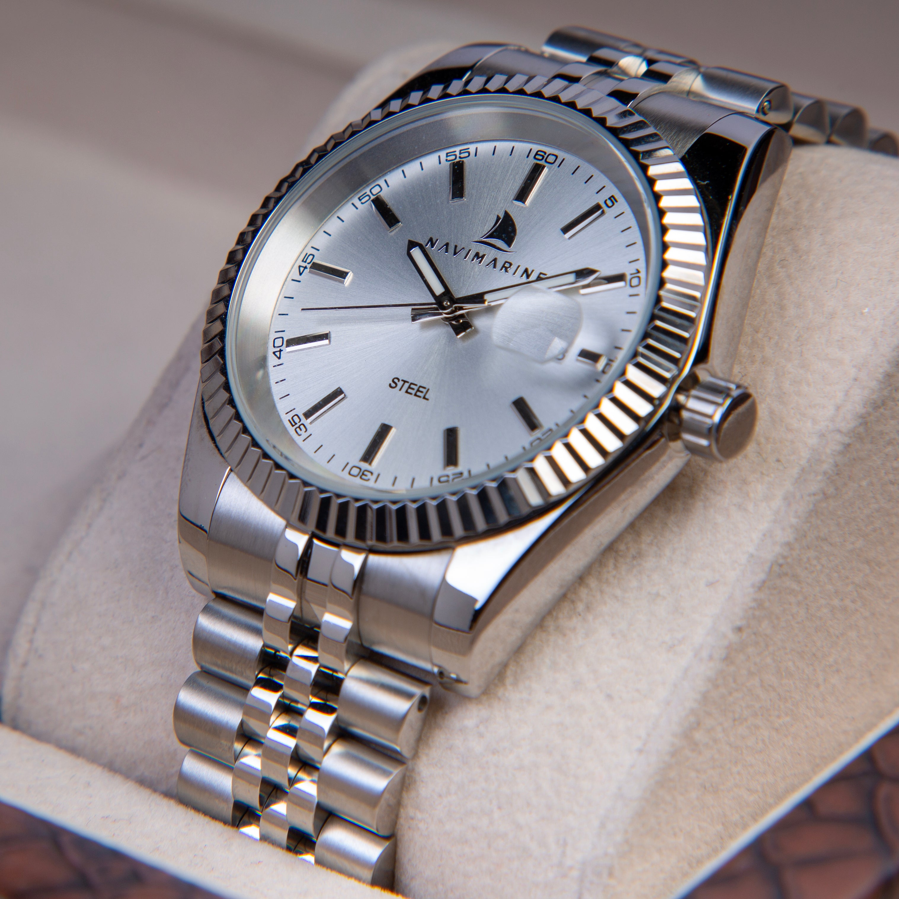 Silver Navimarine watch on a textured surface
