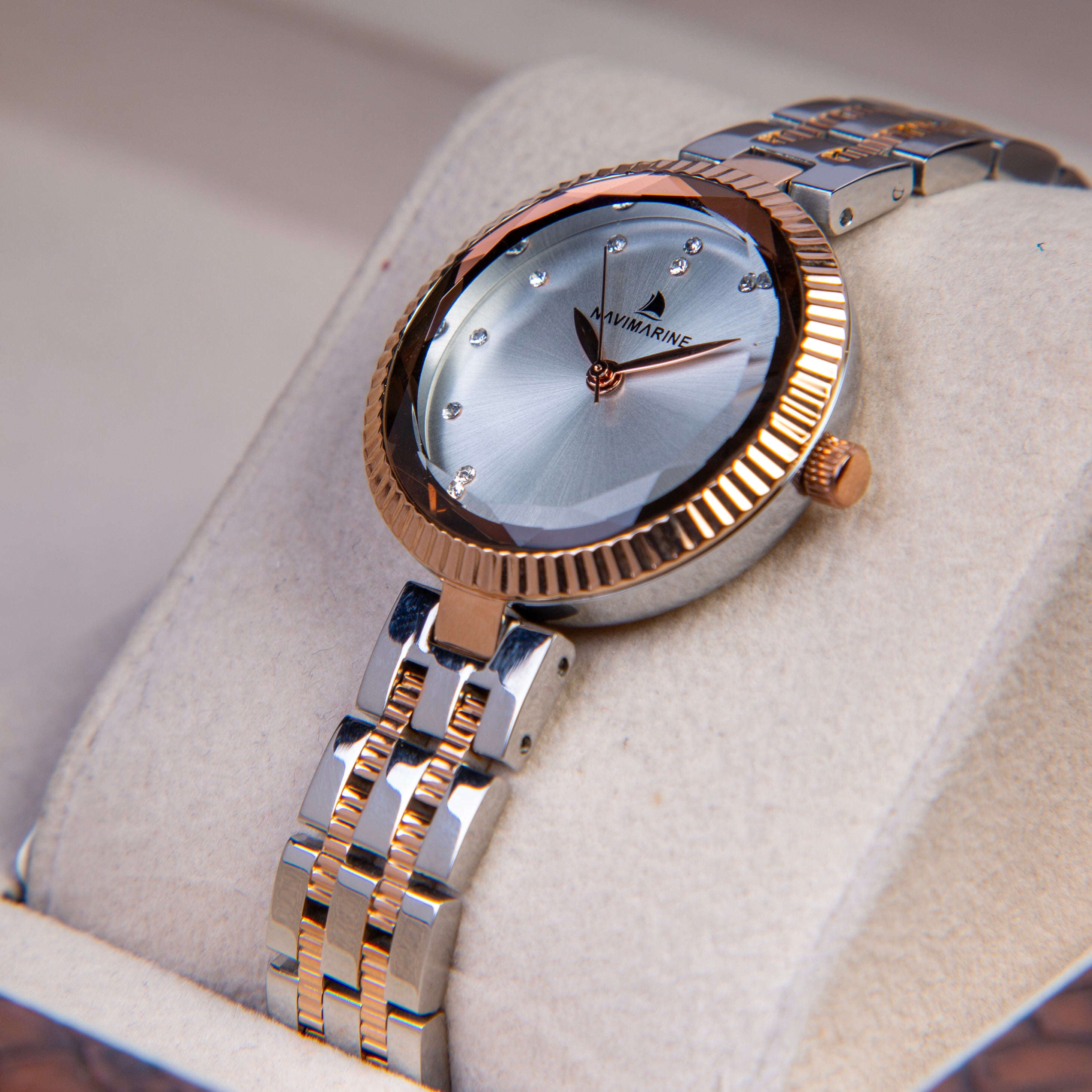 Luxury watch with gold and silver band on a soft surface