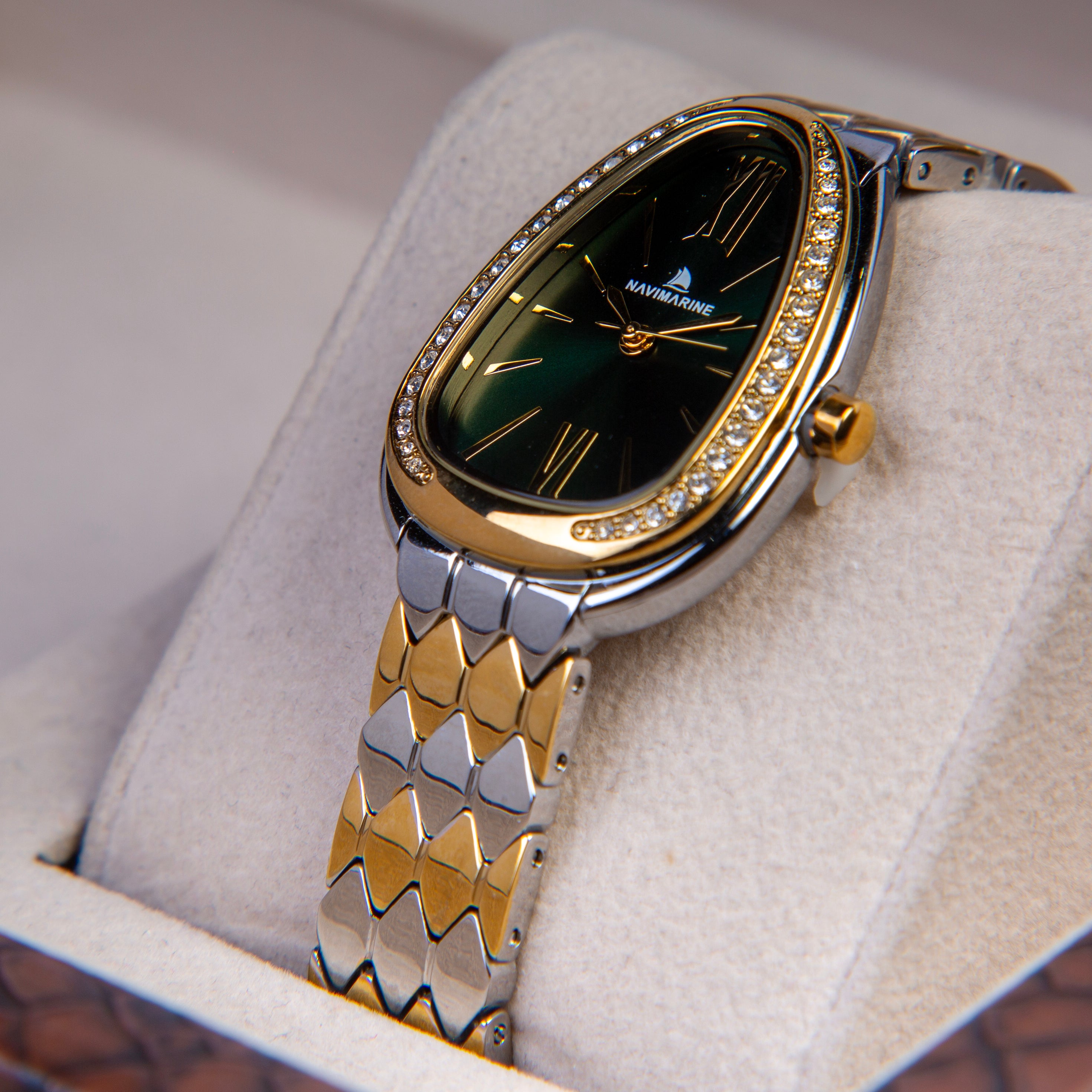 Luxury watch with gold and silver design on a white cushion