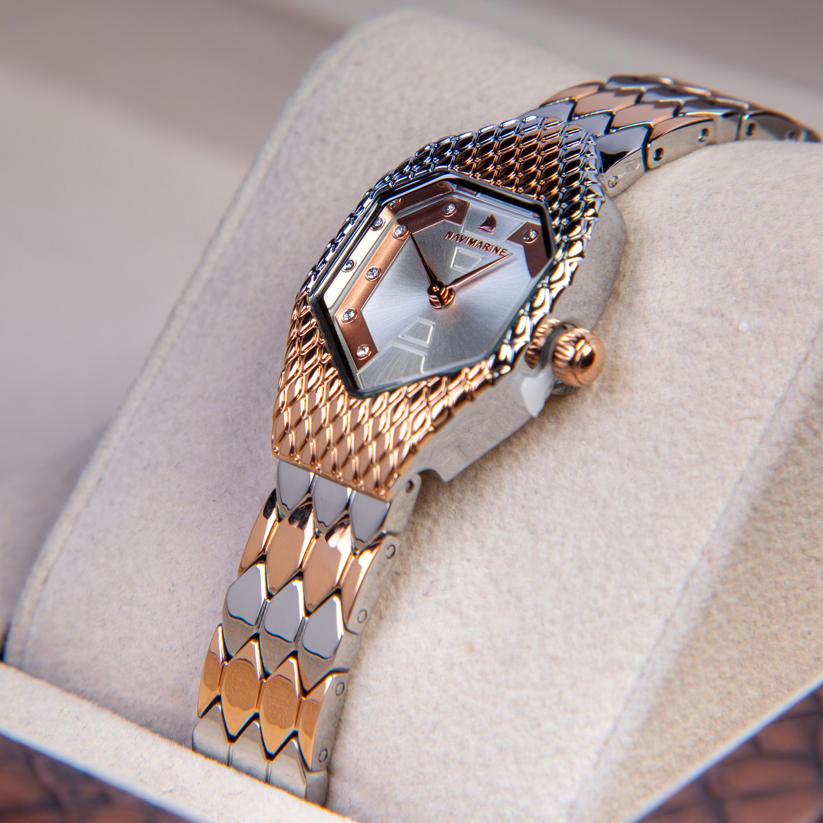 Luxury watch with gold and silver band on a soft surface