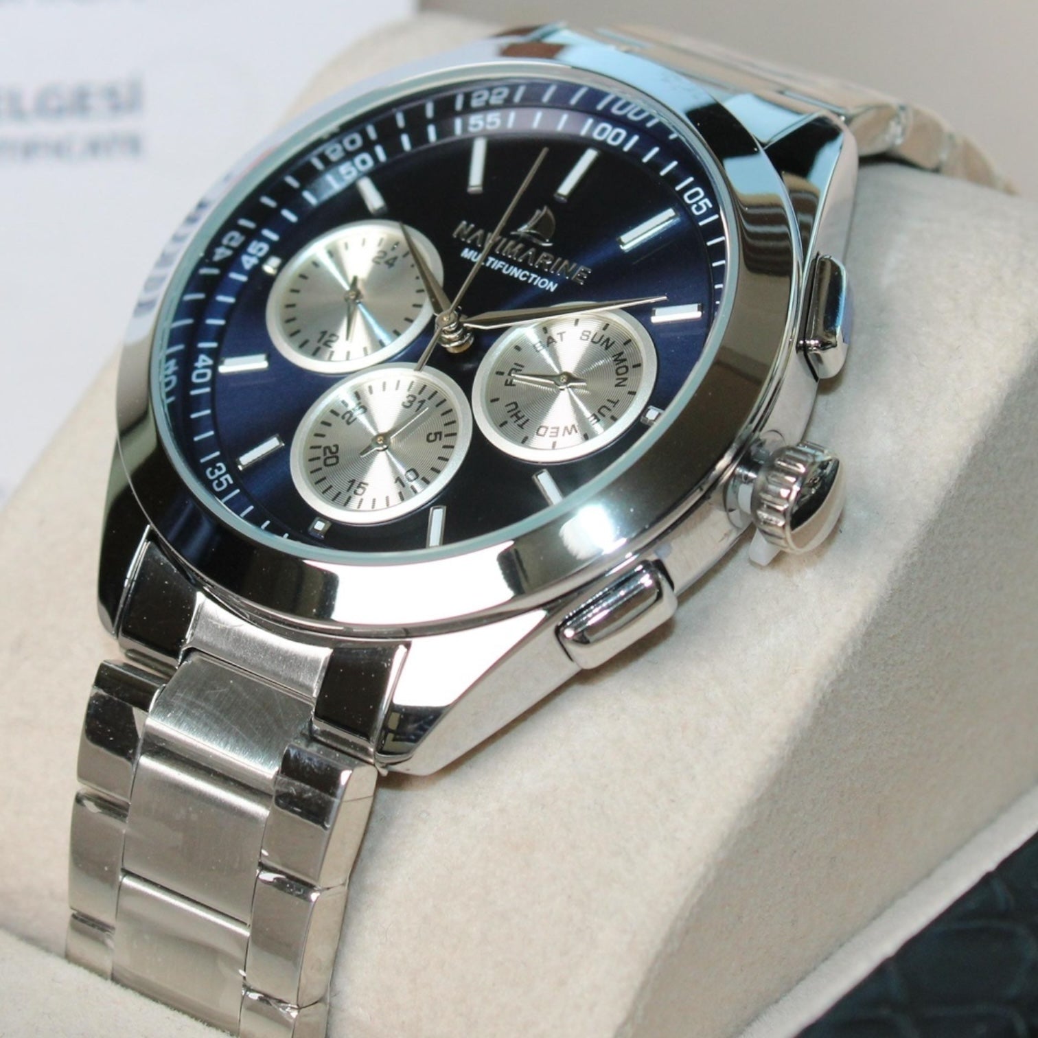 Silver watch with a blue face on a light background