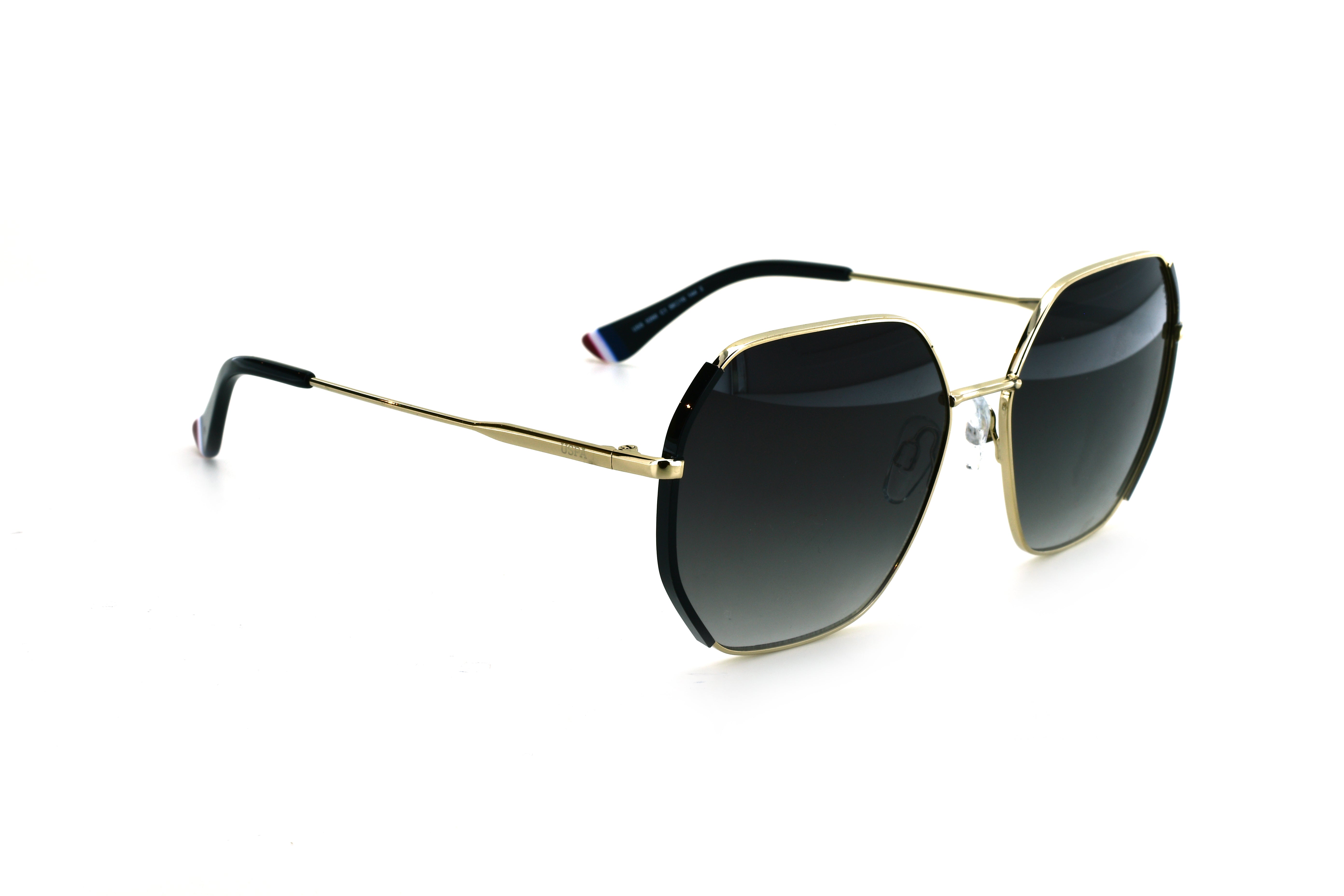 Sunglasses with gold frame and dark lenses on a white background
