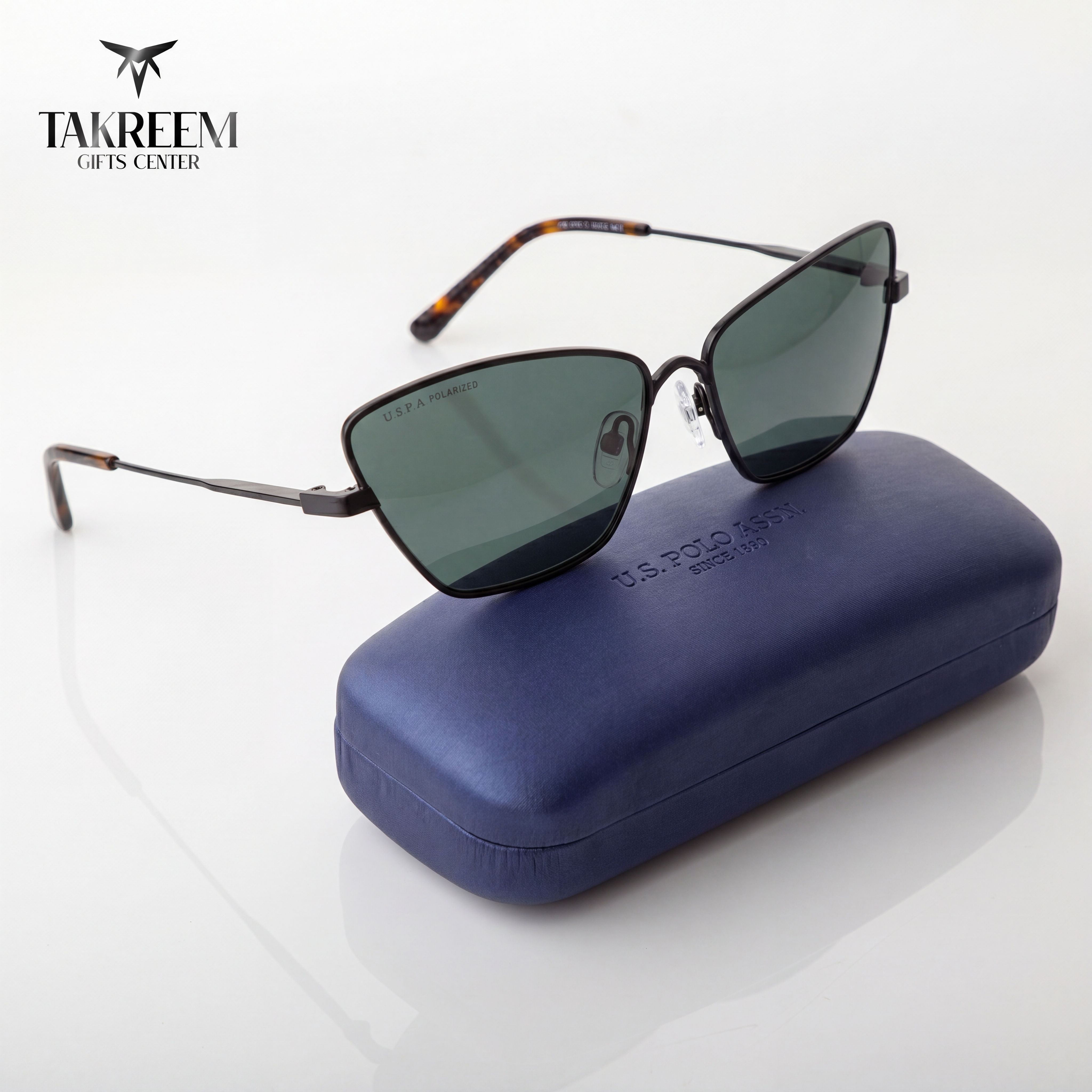 Sunglasses with a blue case on a white background, featuring the Takreem Gifts Center brand.