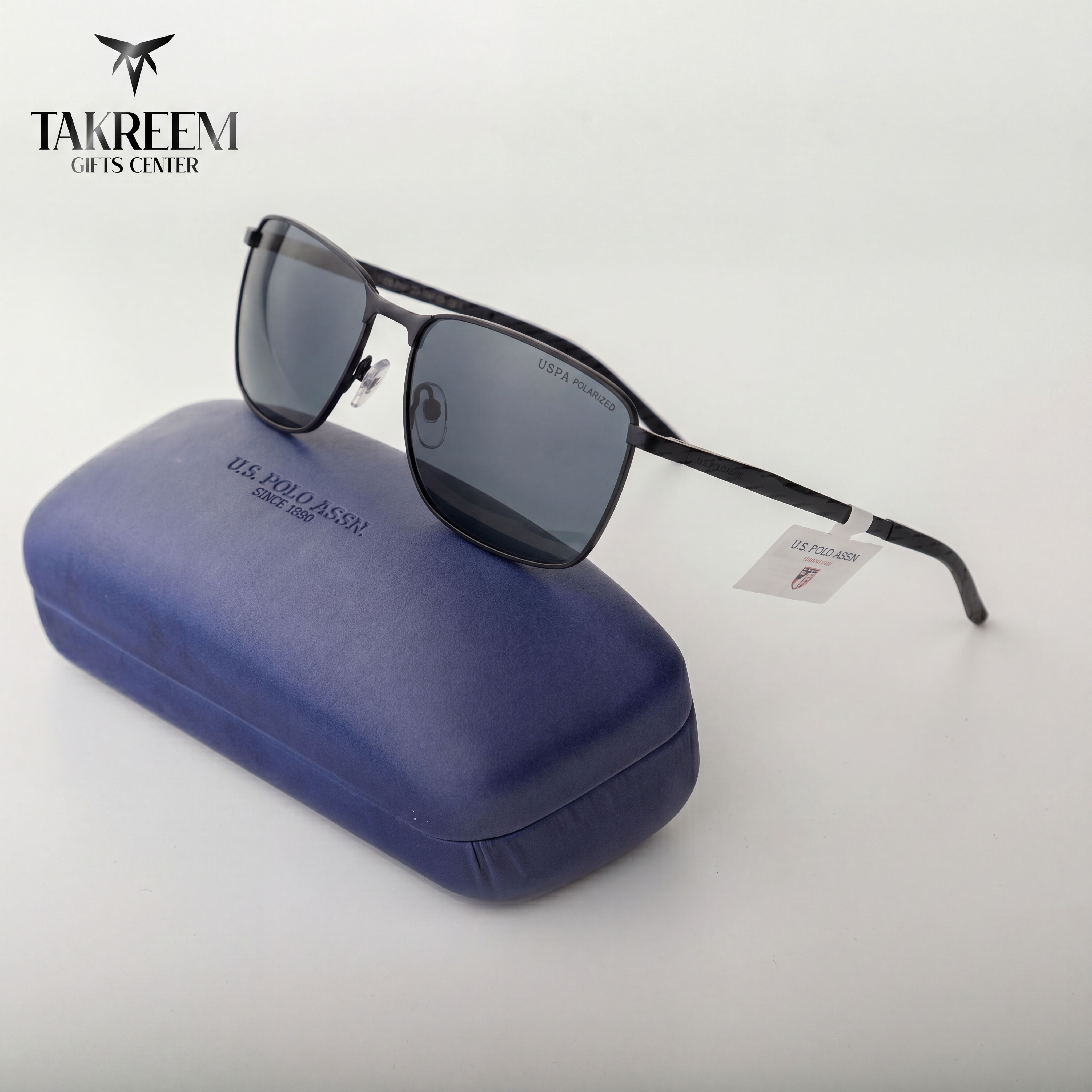 Sunglasses with a blue case on a white background, featuring Takreem Gifts Center branding.