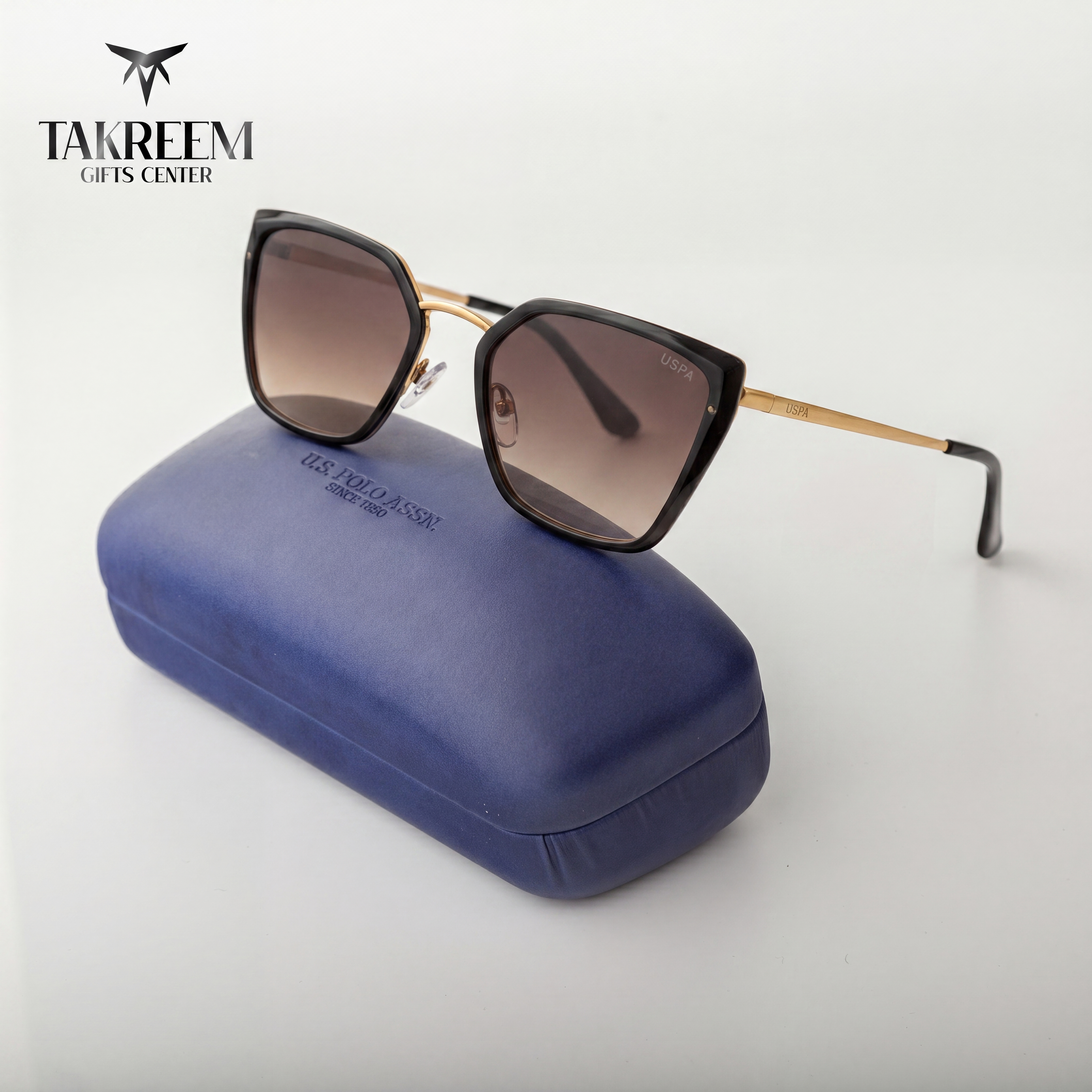 Sunglasses with a blue case on a white background, featuring the Takreem Gifts Center logo.