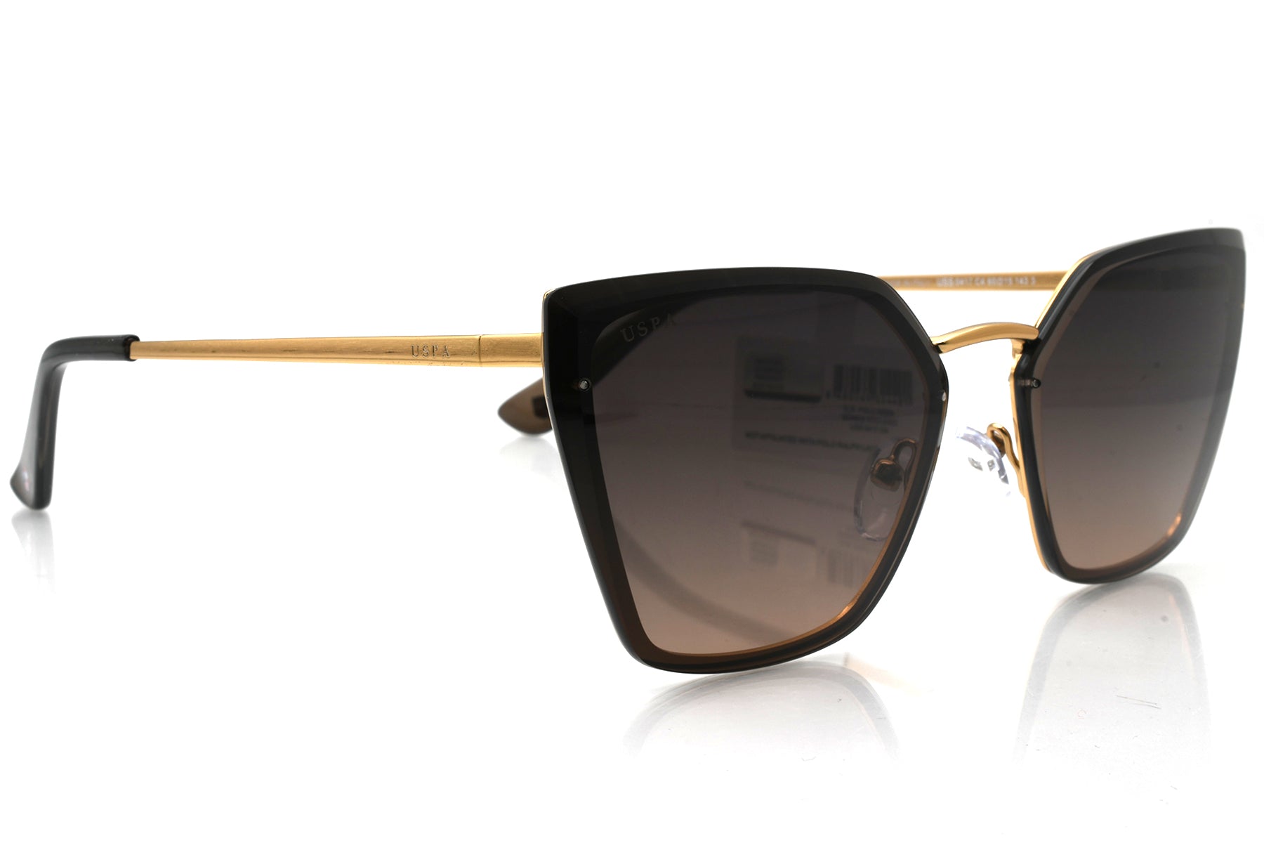Sunglasses with black lenses and gold frame on a white background
