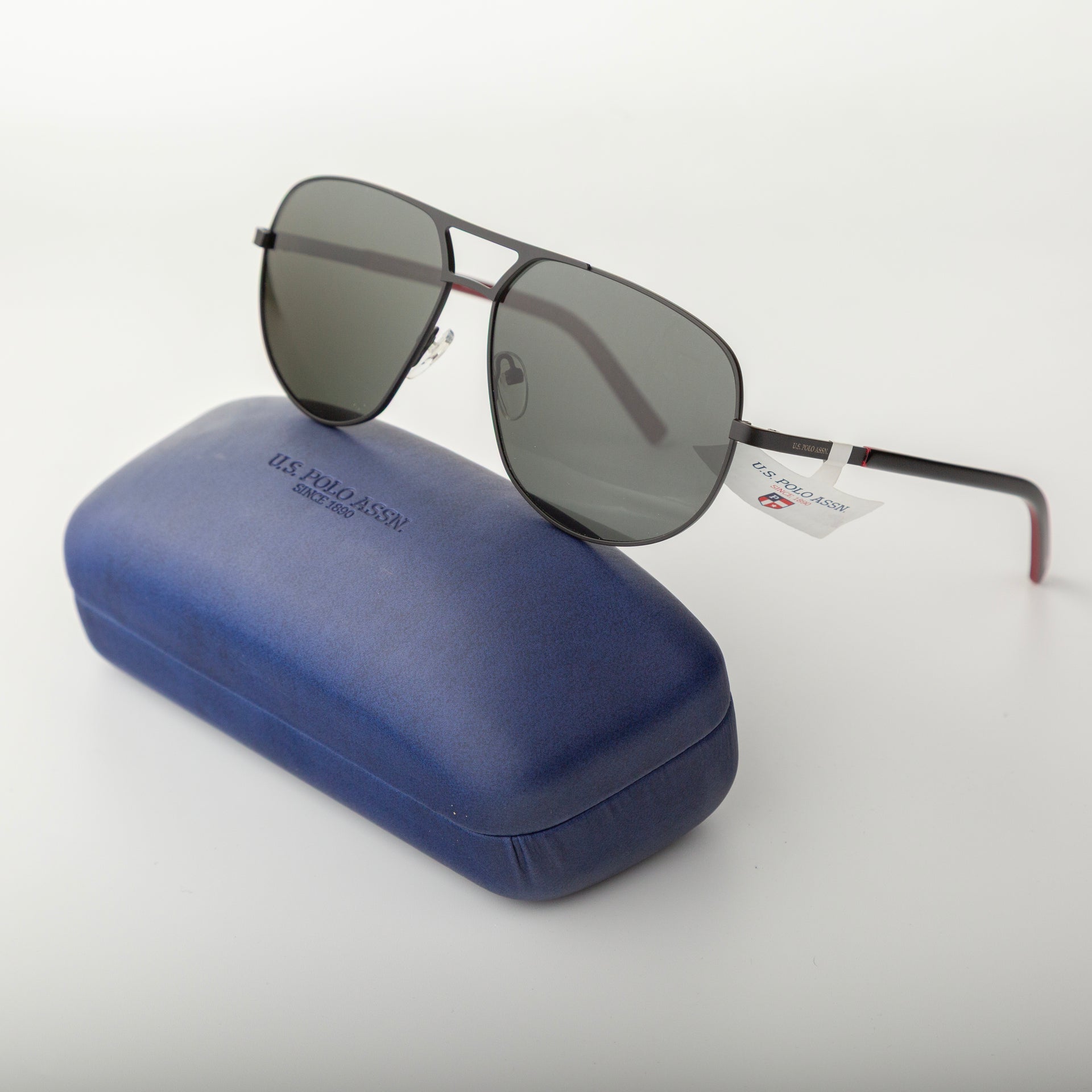 Sunglasses with a blue case on a white background