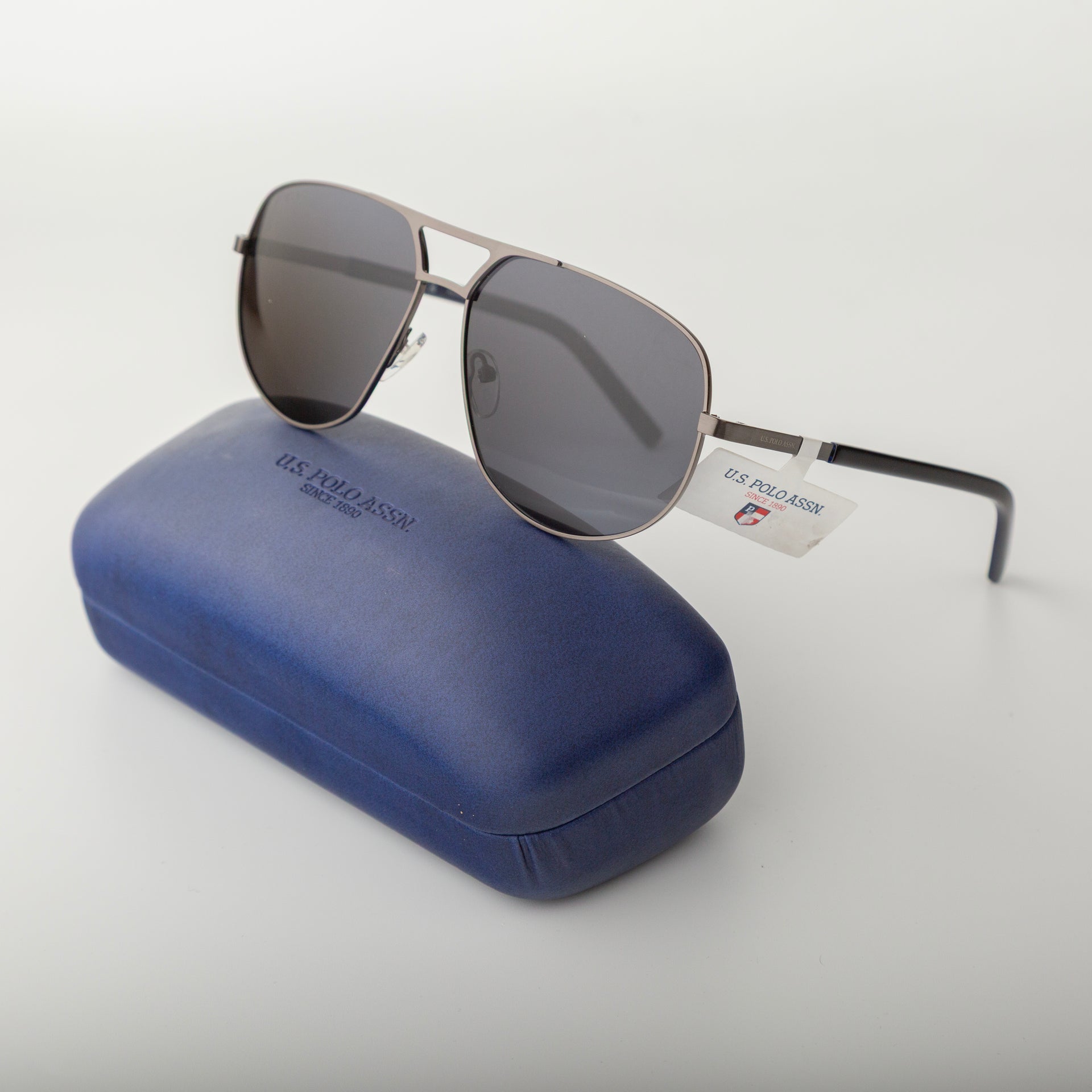 Sunglasses with a blue case on a white background