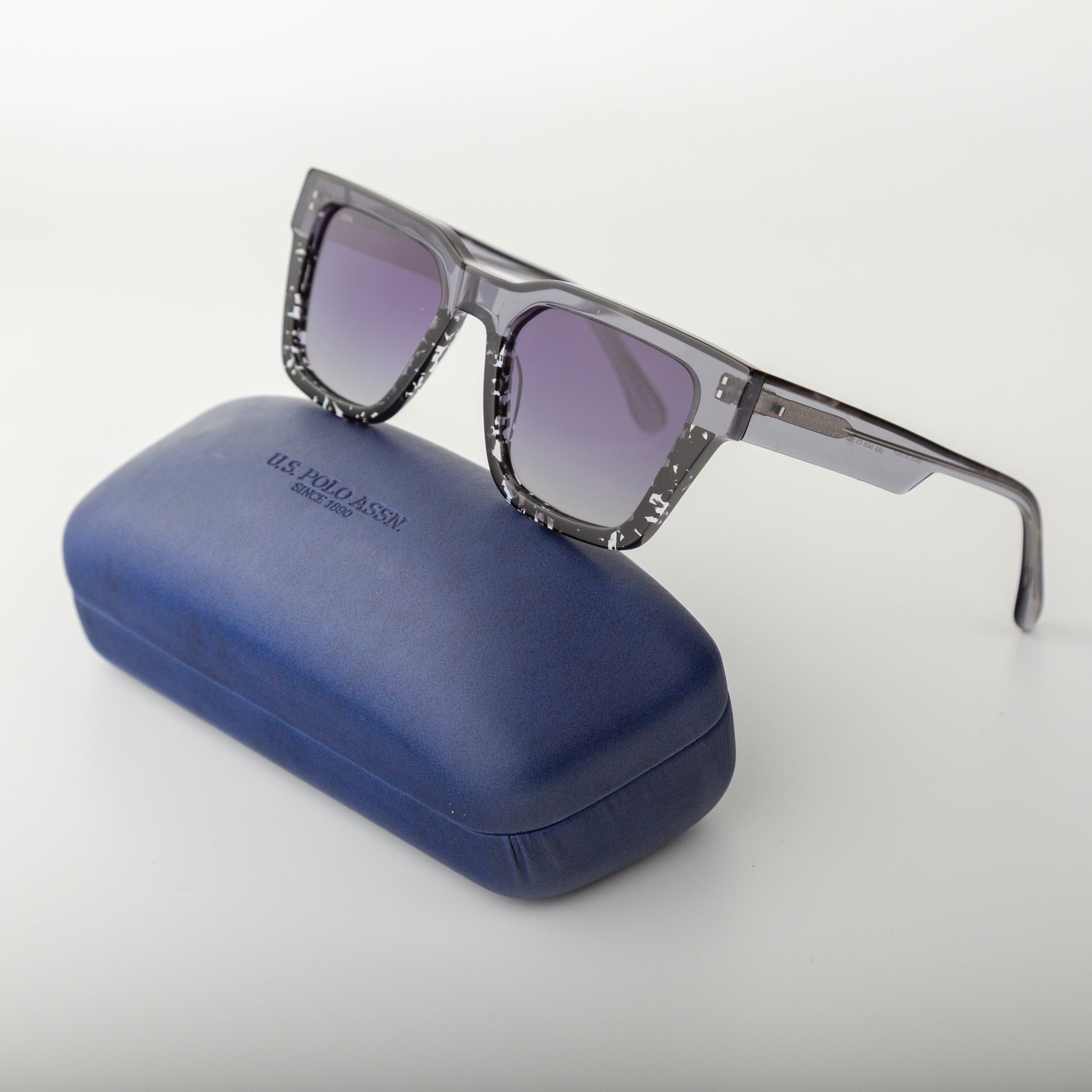 Sunglasses with a blue case on a white background