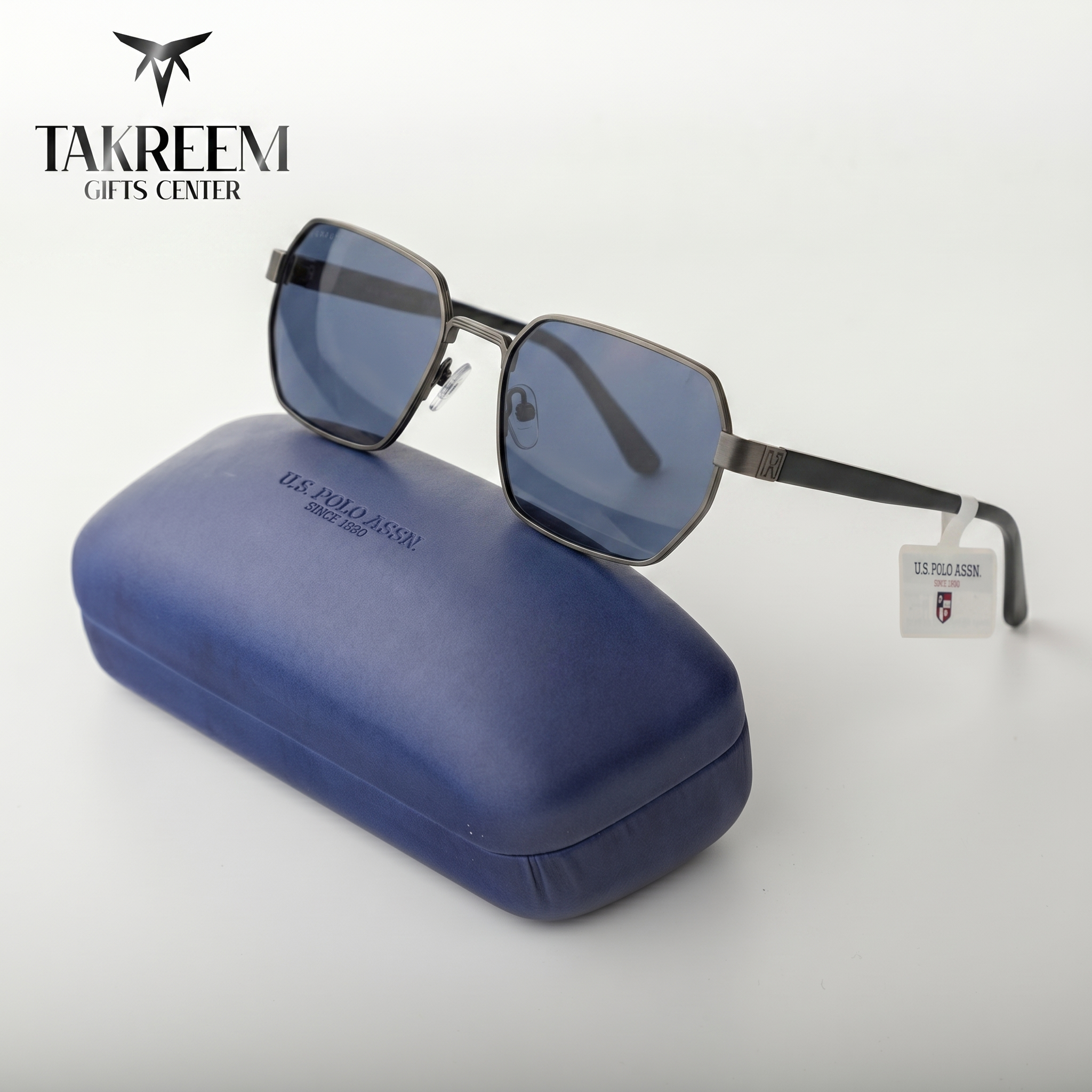 Sunglasses with a blue case on a white background, featuring the Takreem Gifts Center logo.