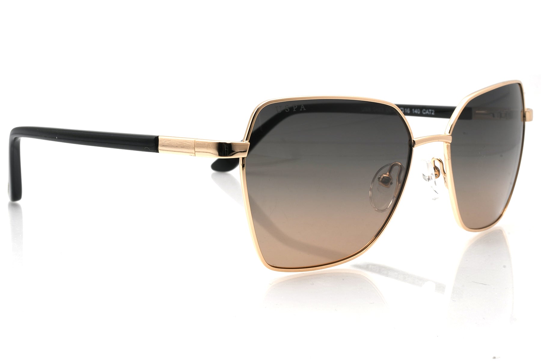 Sunglasses with gold frame and black arms on a white background