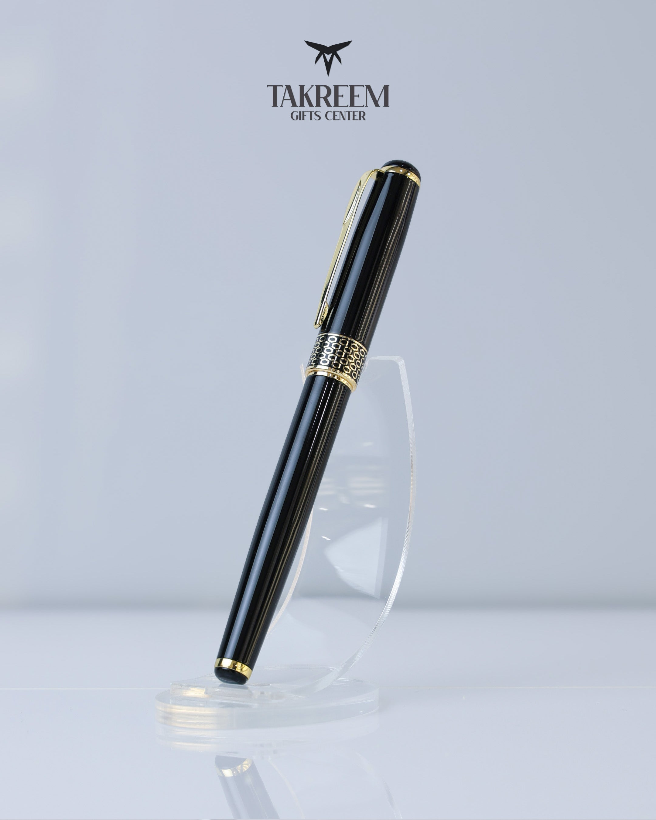 Black and gold pen with Takreem Gifts Center logo on a light gray background