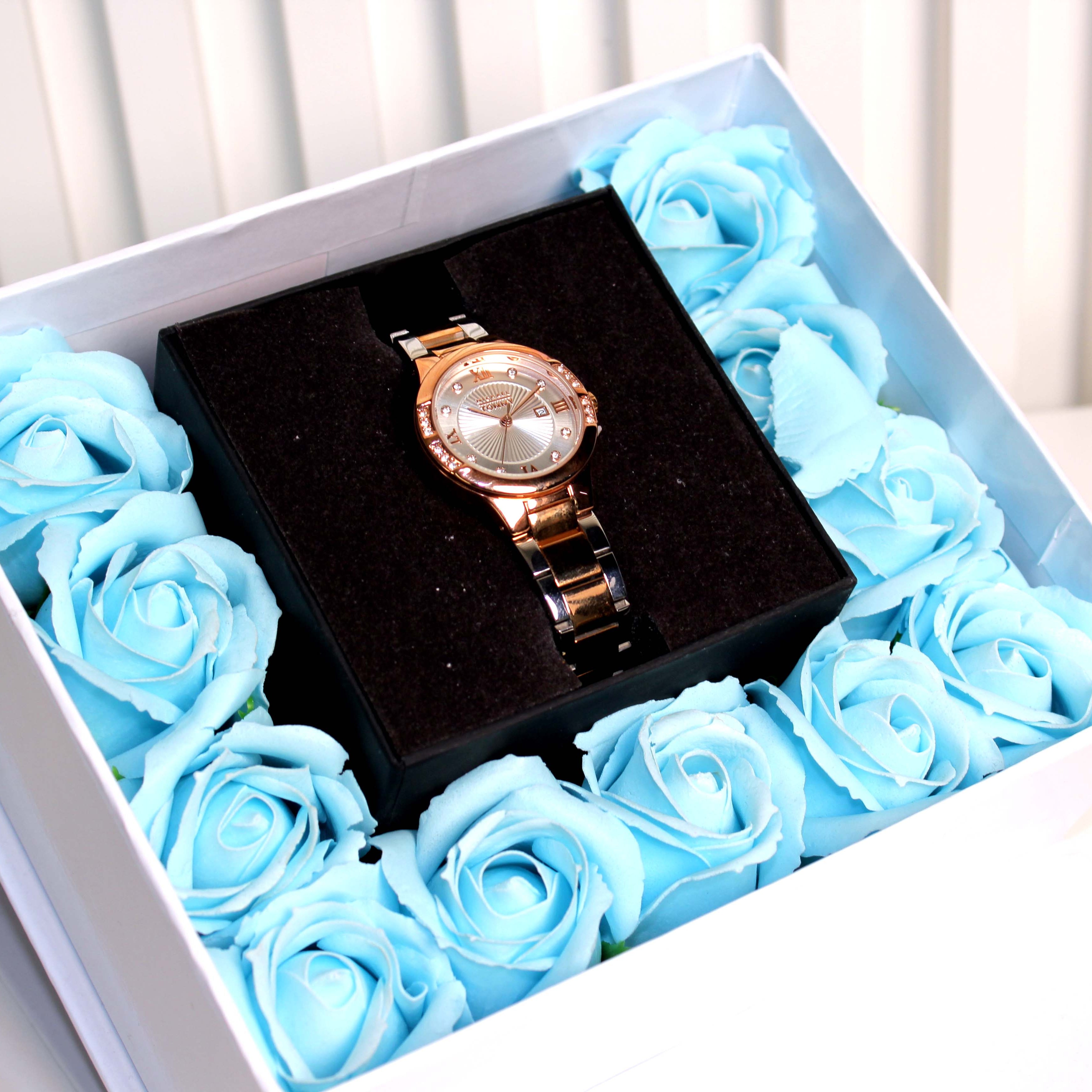 Rose gold watch in a box with blue roses