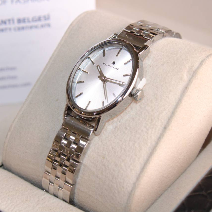 Silver watch on a display stand with a blurred background
