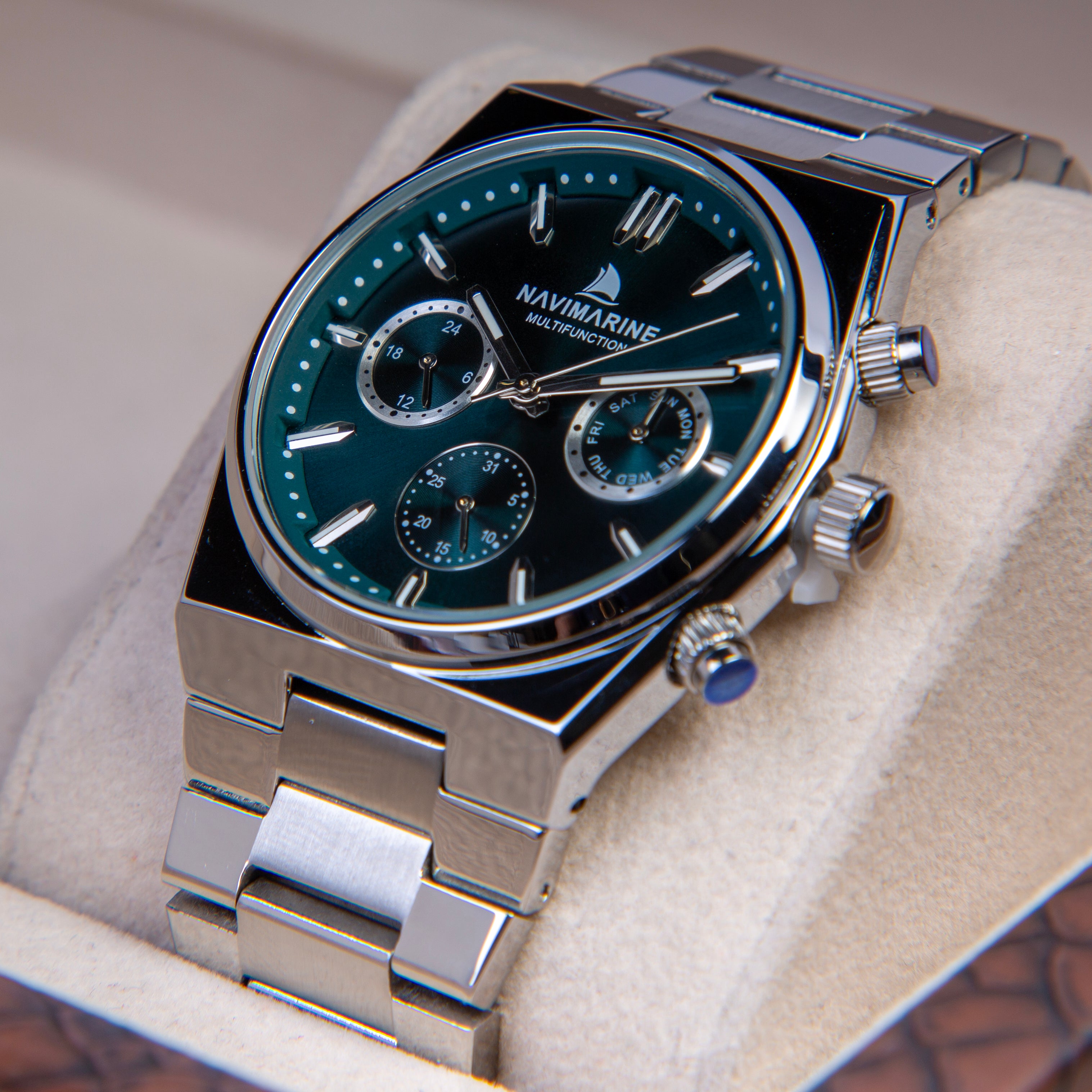 Navimarine watch with silver metal band and green dial on a light background