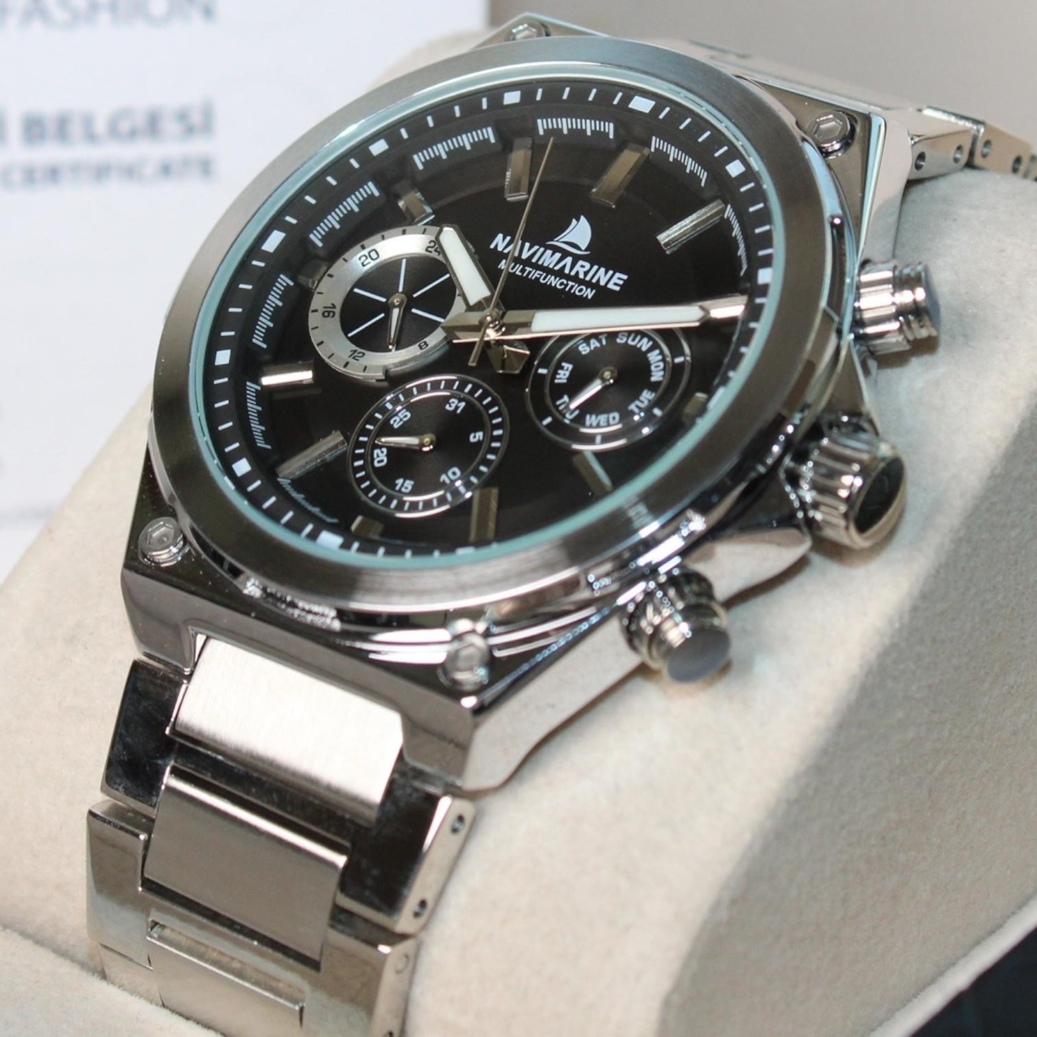 Silver Navimagine watch with black face on a white background