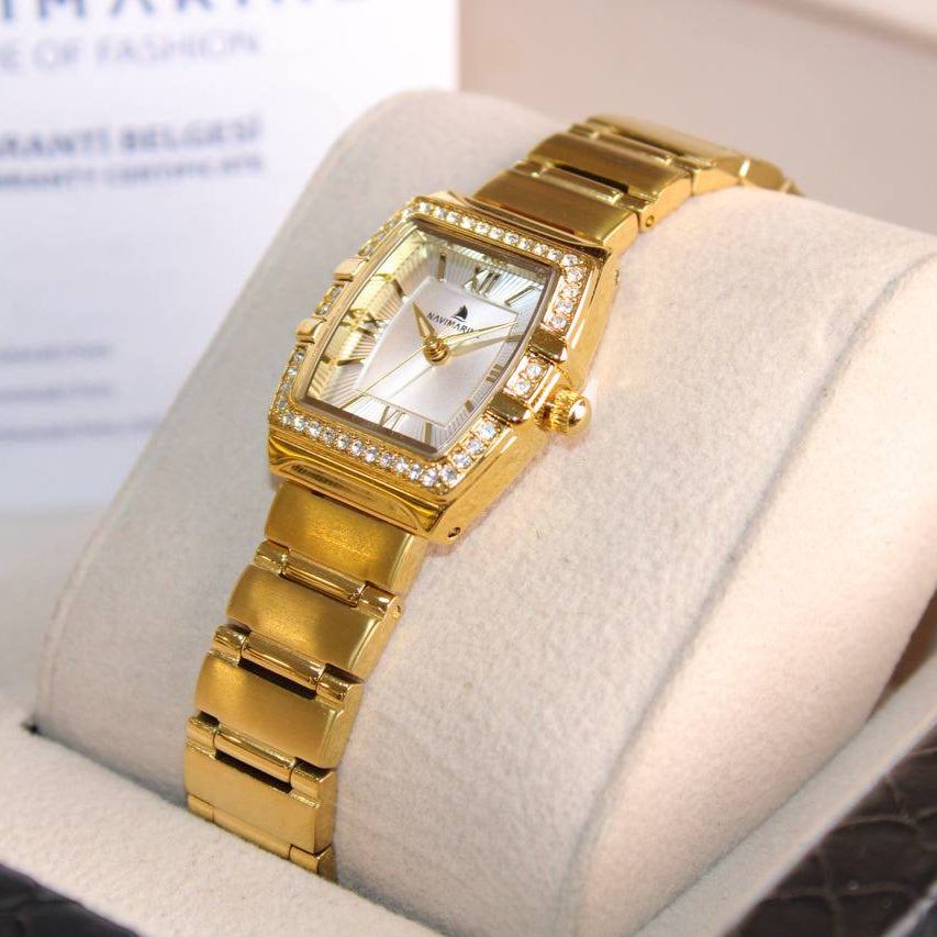 Gold wristwatch on a display stand with a blurred background