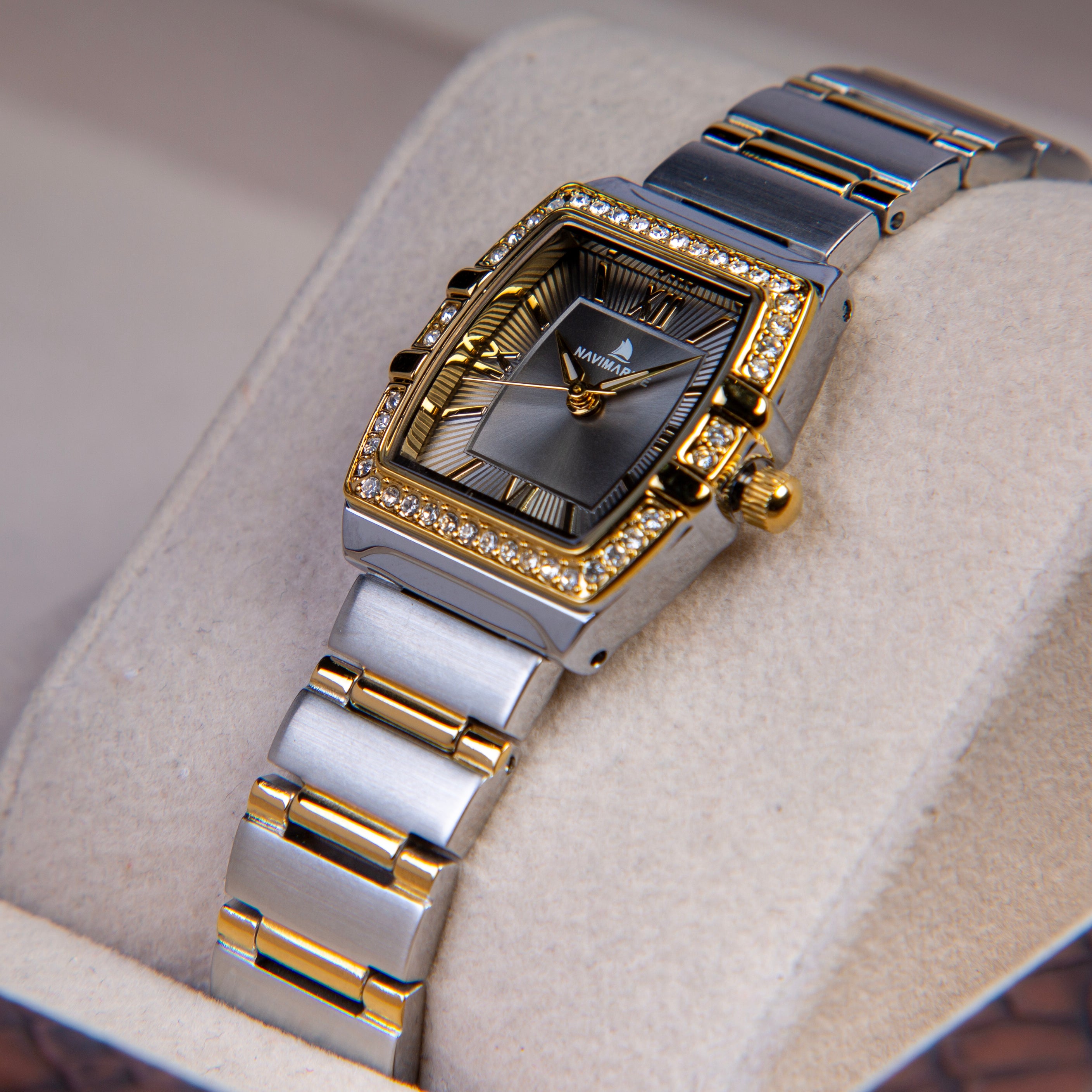 Luxury watch with silver and gold band on a soft surface